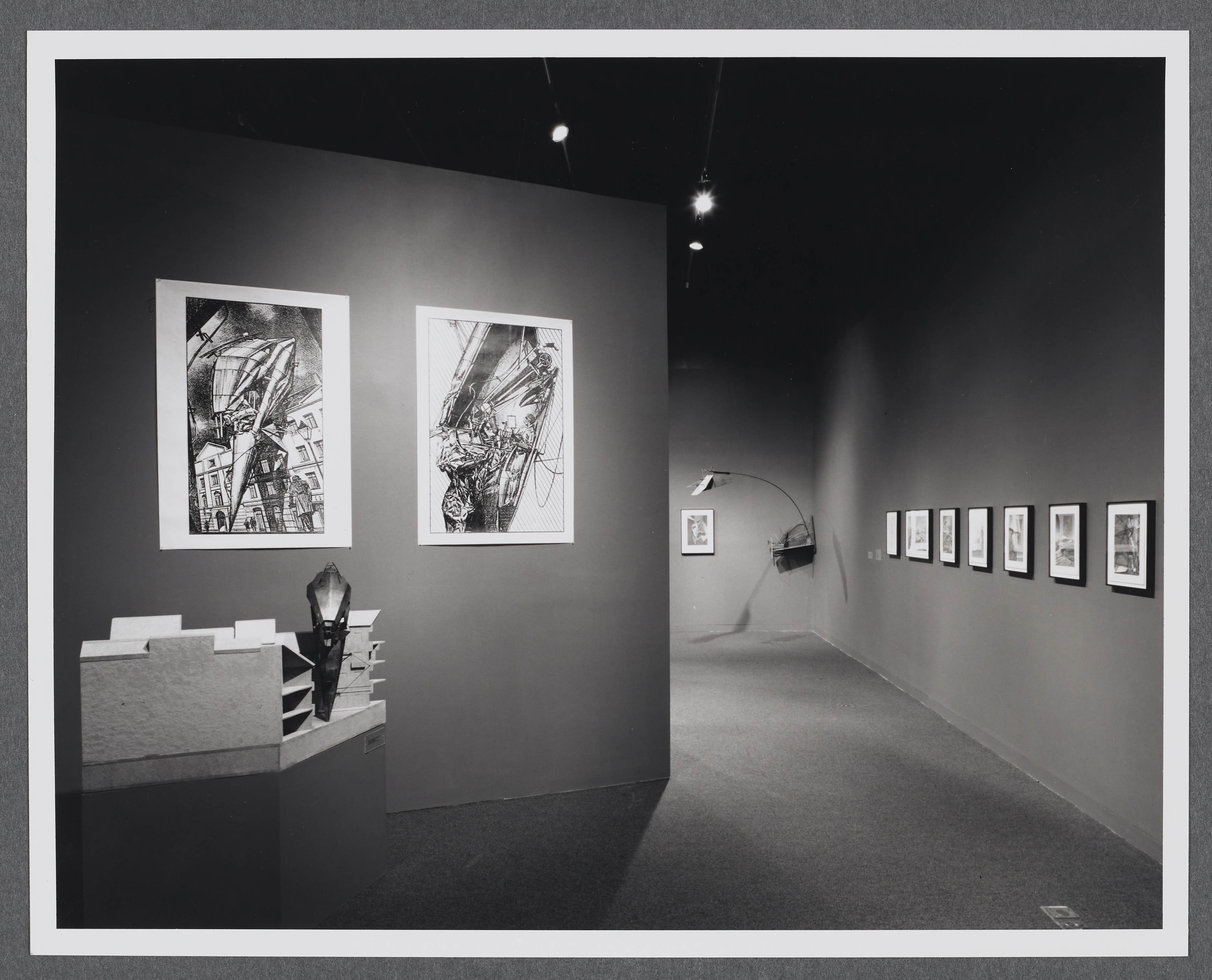 3D models sit on pedestals around the gallery. Large scale drawings hang on the gallery walls alongside the models.