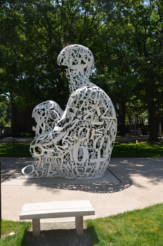 Sculpture made of tainless steel, white enamel paint featuring collages of letters, numbers, or symbols that appear to be in the process of organization.
