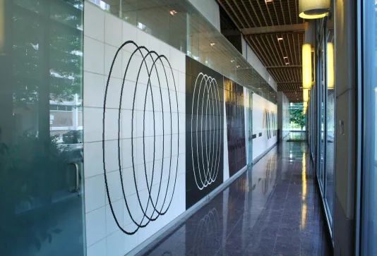 225-foot-long ceramic mural installed along a hallway with one long wall of windows