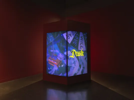 Two adjacent screens show a blue-tinted tableau, the right screen overlaid with the word “Dusk” in yellow, gothic font.
