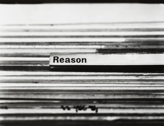 Detail image of many file folders in a row. There is one label tab highlighted with black bolded text. The text reads "Reason"