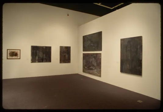 Six varyingly sized pastel sketches of human figures in muted greyscale color tones hang on adjacent gallery walls.