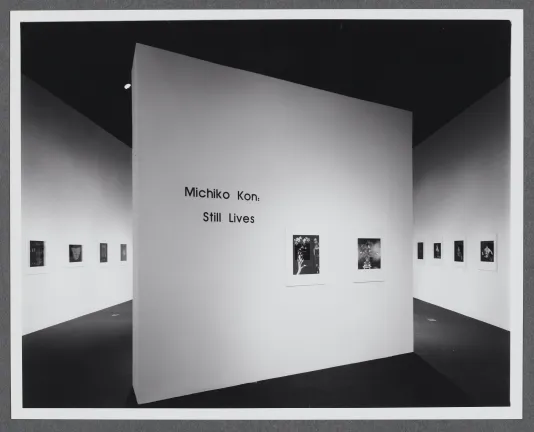 The title wall for Michiko Kon: Photographs sits at a diagonal in the center of the gallery space. Two photographs are displayed. 