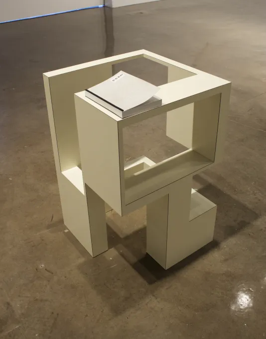 White cubic sculpture about 2 feet high.