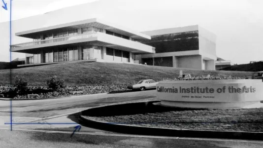 A black and white image, with blue ink on the left side, of a structure with glass walls. To the right, a sign reading CalTech.