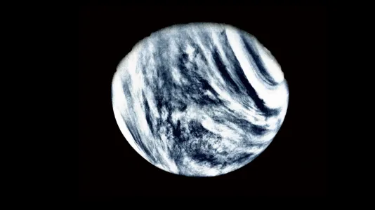 A luminous sphere against black, perhaps a planet with black and white swirling clouds