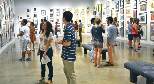 Students fill gallery looking at art.