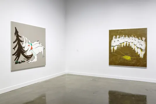 2 large paintings on adjacent white walls, 1 on left shows 3 men in red, green underwear kneeling with brown tree behind them.