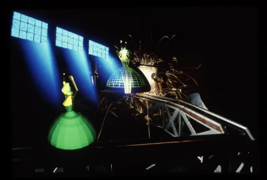 Video still showing light streaming through 3 windows into industrial space superimposed with images of dress forms.