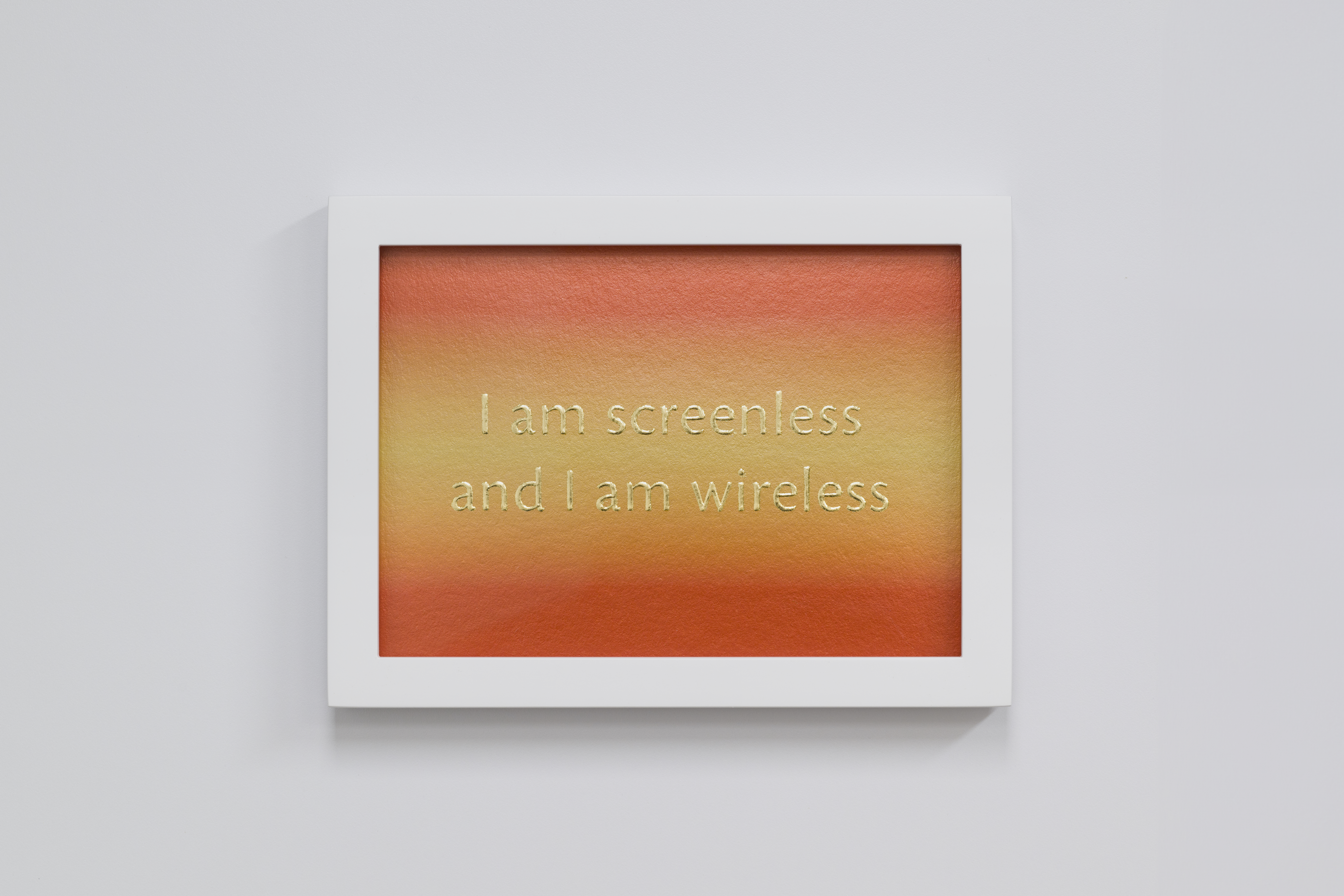 Bright orange and yellow ombre with two line of shimmery gold text and a white frame. The text reads &quot;I am screenless and I am wireless&quot;