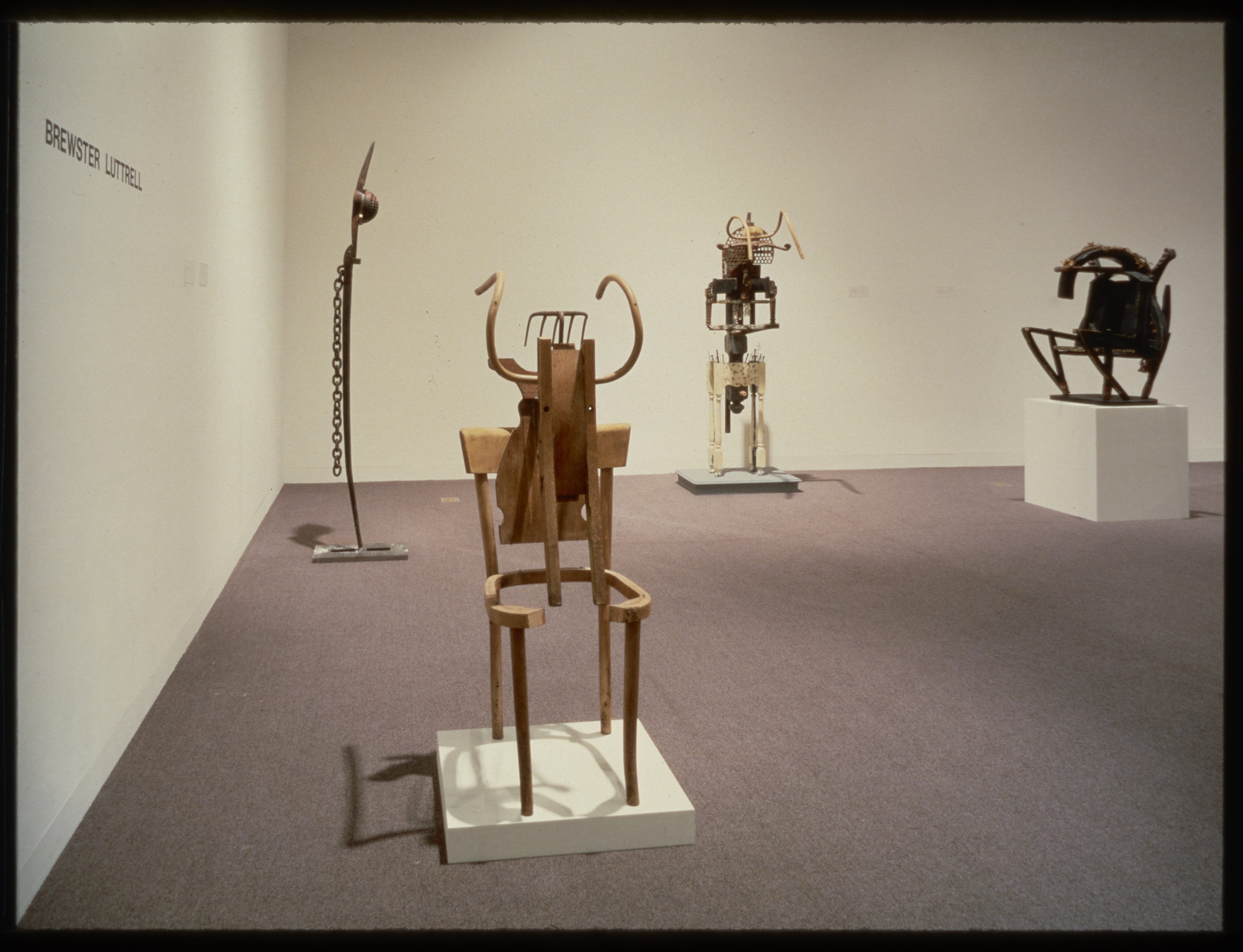 Abstract sculptures are scattered around the gallery. Each is propped up on pedestals and made from a range of materials.