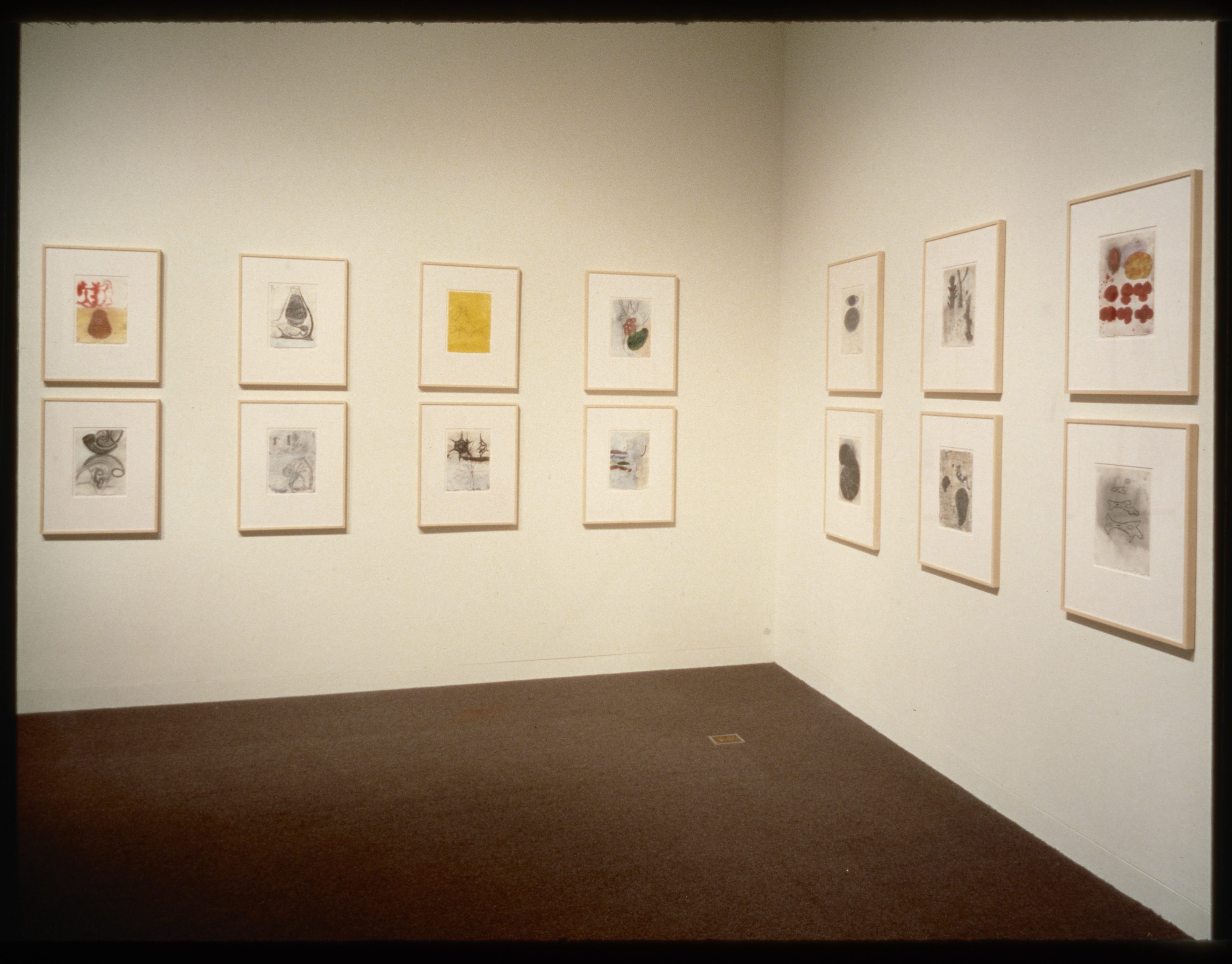 Works hang in two equal rows going around the gallery walls. The works hang in pairs where one is on top of the other.