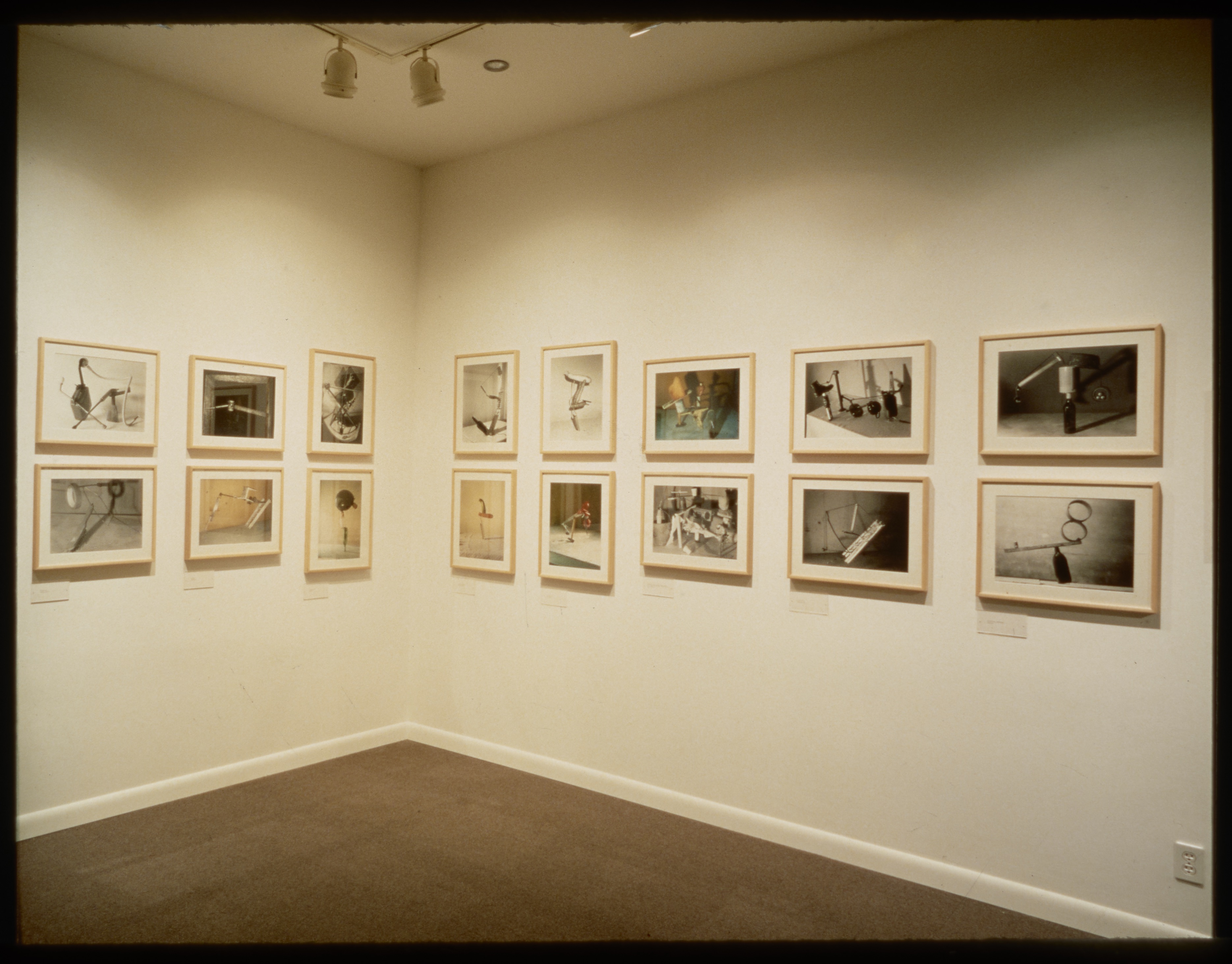 Works hang in two equal rows going around the gallery walls. The works hang in pairs where one is on top of the other.