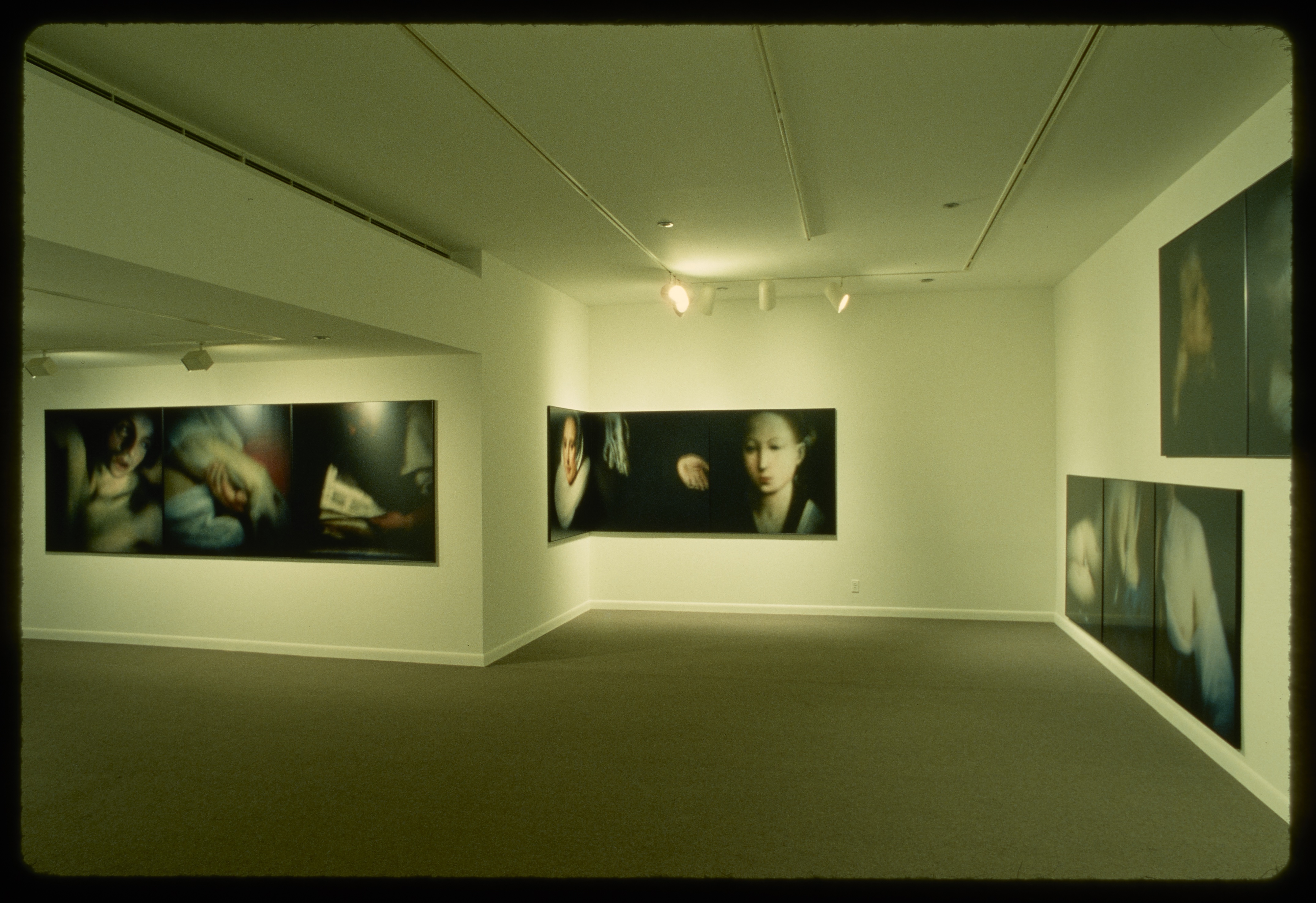 Triptychs line the walls of the gallery. Each of the three pieces in the triptics shows a detail from a historical artwork.