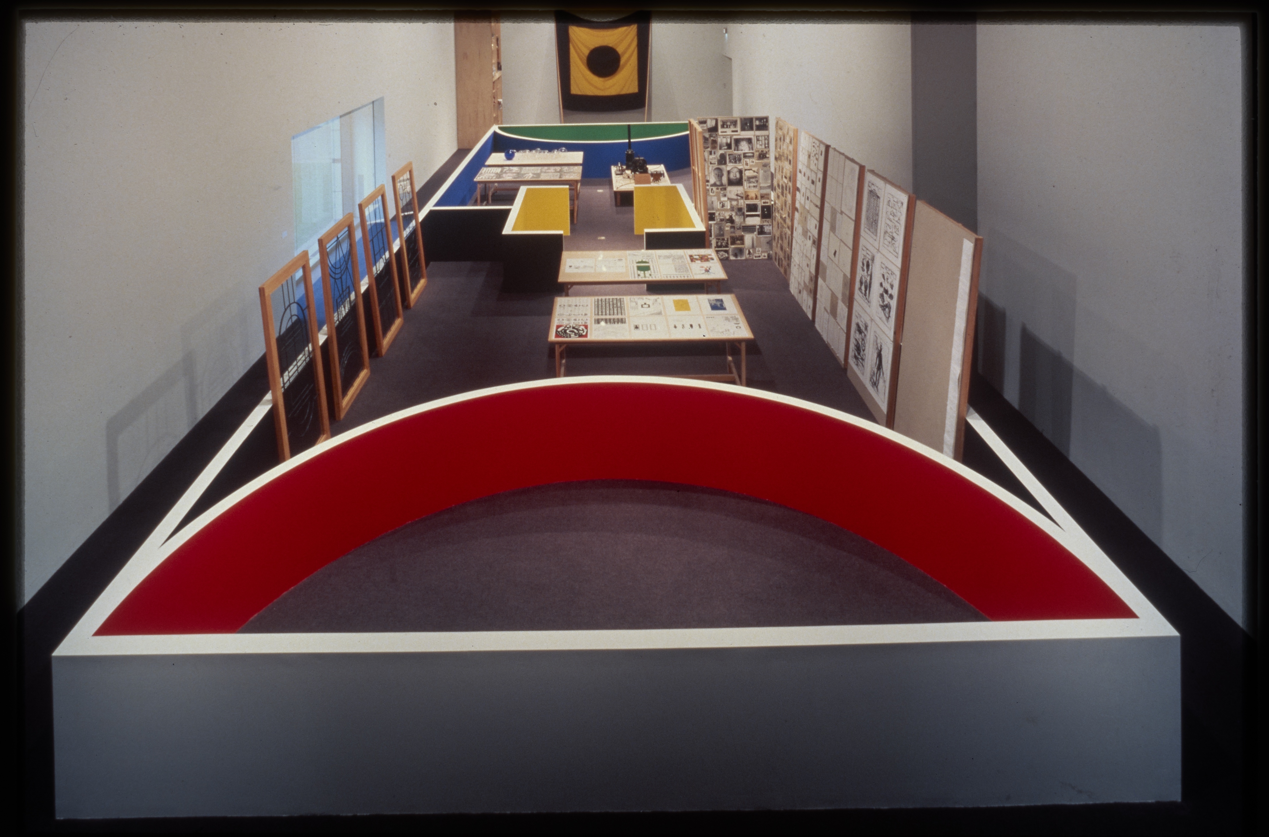 Short gallery walls create an architectural space within the gallery. Viewers can walk through and view a variety of objects.