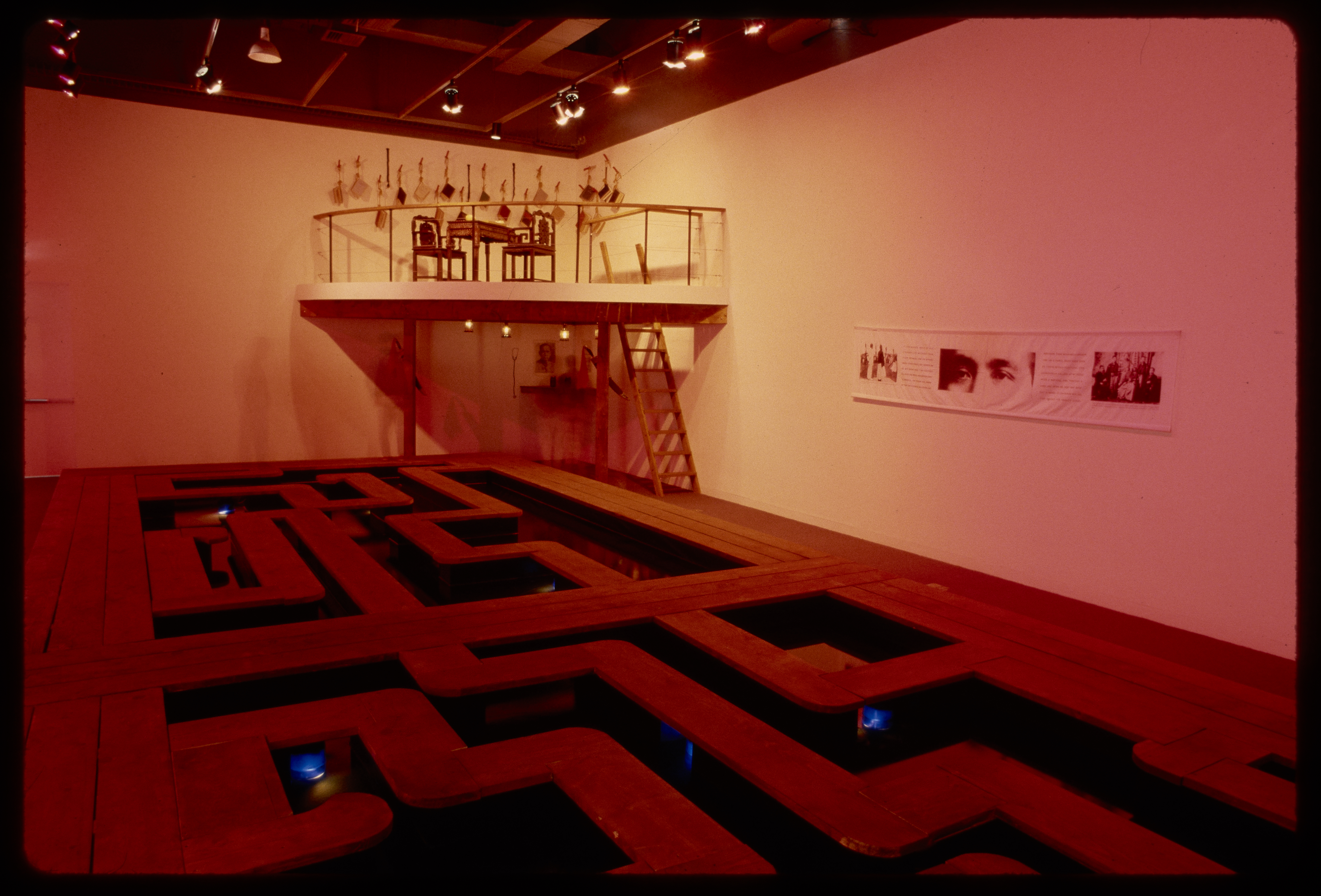 A walkway takes up the gallery while a rafter is set up the wall in the back corner. A ladder is set to climb the rafter.