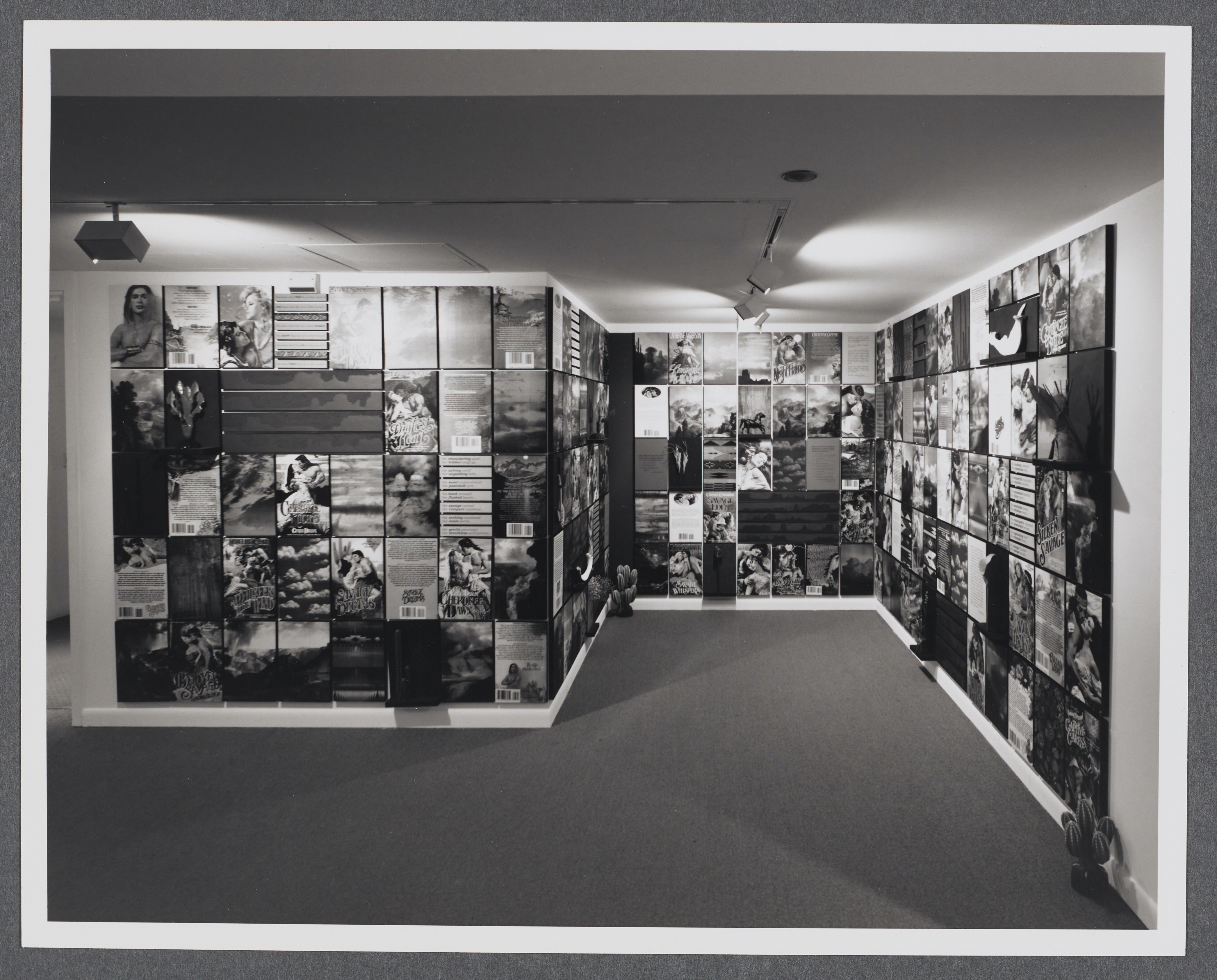 A grid of photographs of historical portraits, documents, and nature images extend across all of the gallery walls.
