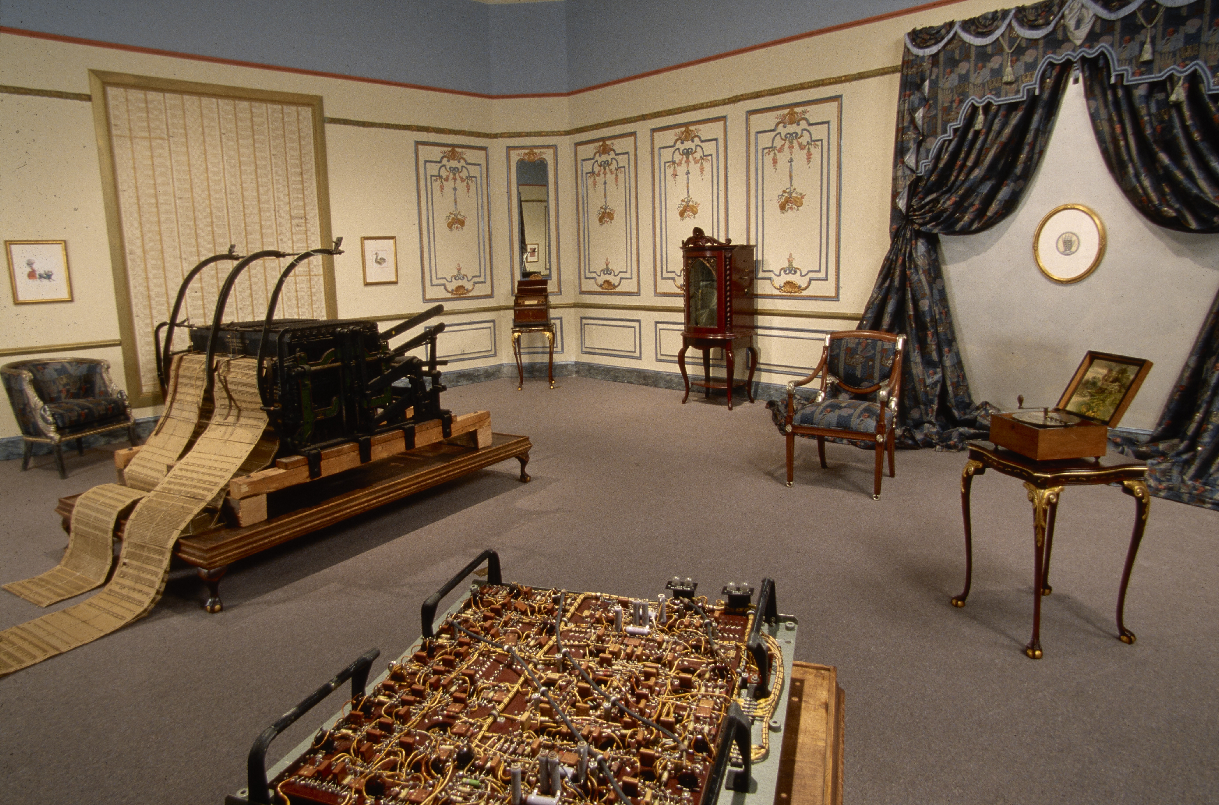1950s table-size computer panel, Jacquard loom and punched cards, music boxes, drapery, painted panels in Baroque-Rococo room