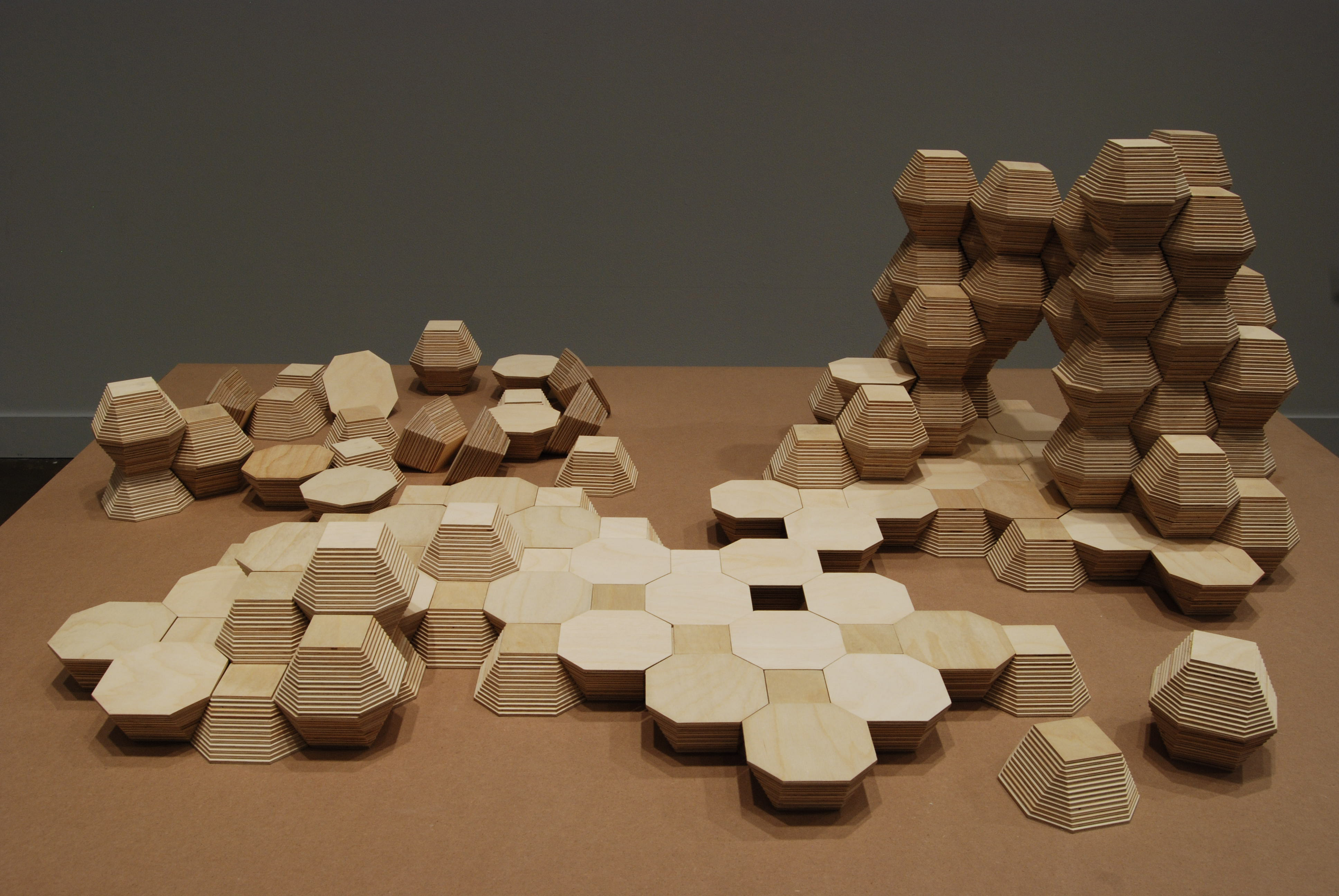 Gray, white and black geometric drawing and rectangular intrusion create optical dimension within a white box.