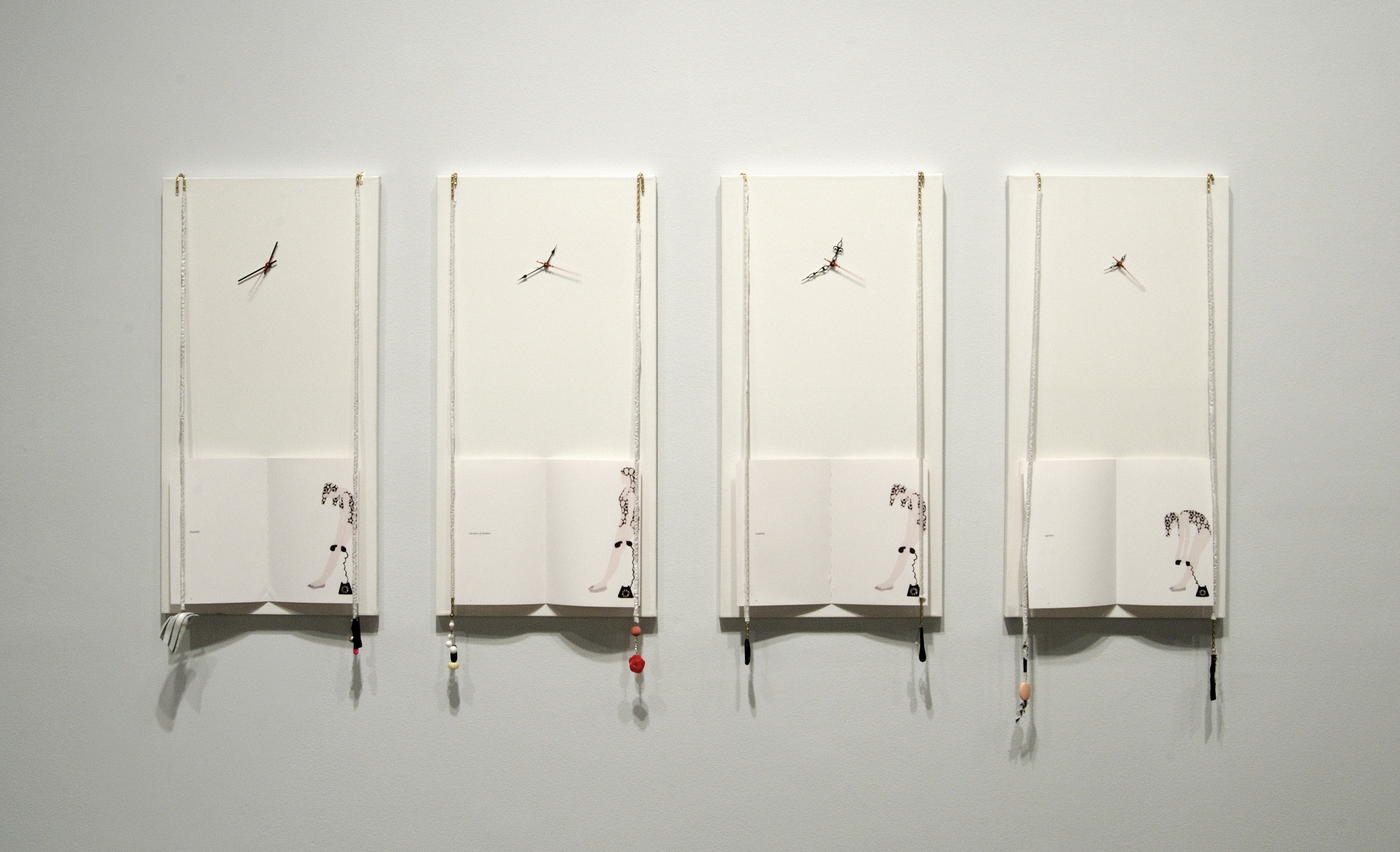 Four white panels hang against the wall. At the bottom, an open book with an illustration of a woman slumped over.