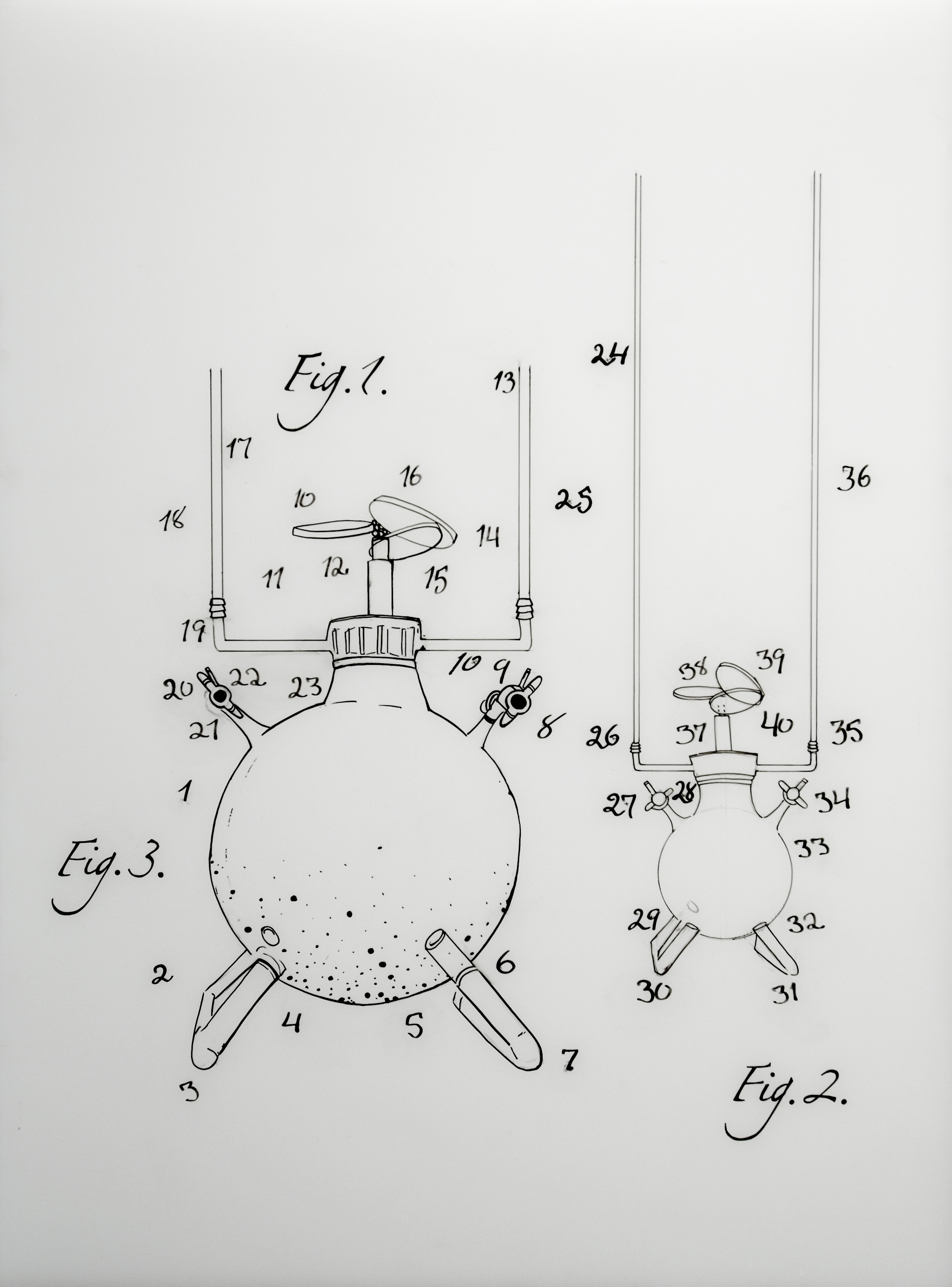 Surrounded by numbers, 2 round shapes with propellers on top and tubular appendages protruding from upper and lower sides