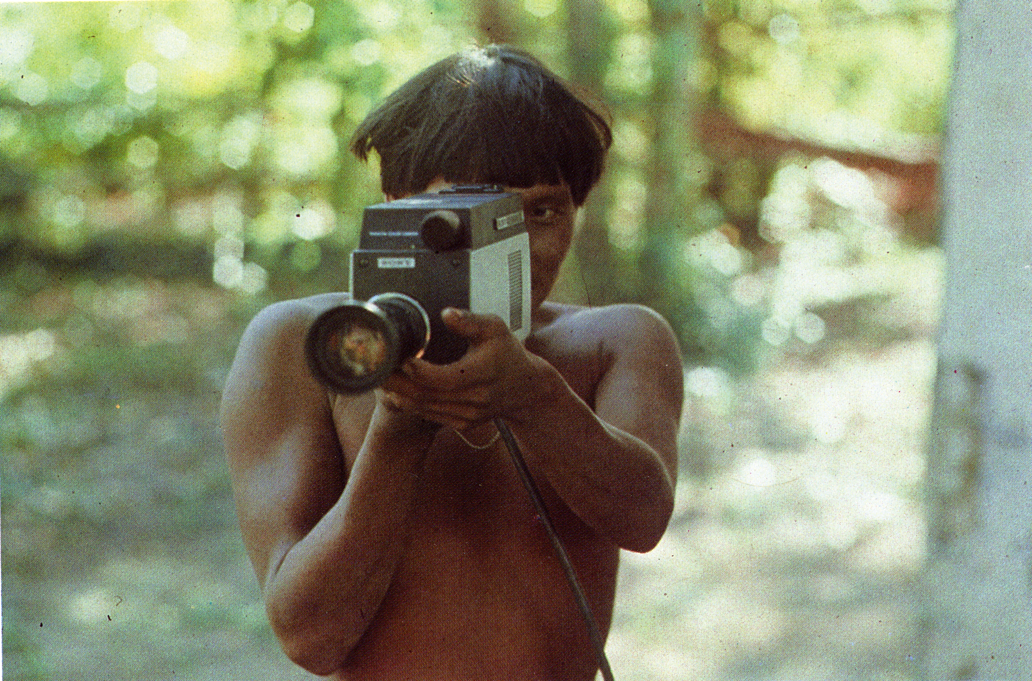Film Still of a Boy holding a camera pointed at the viewer