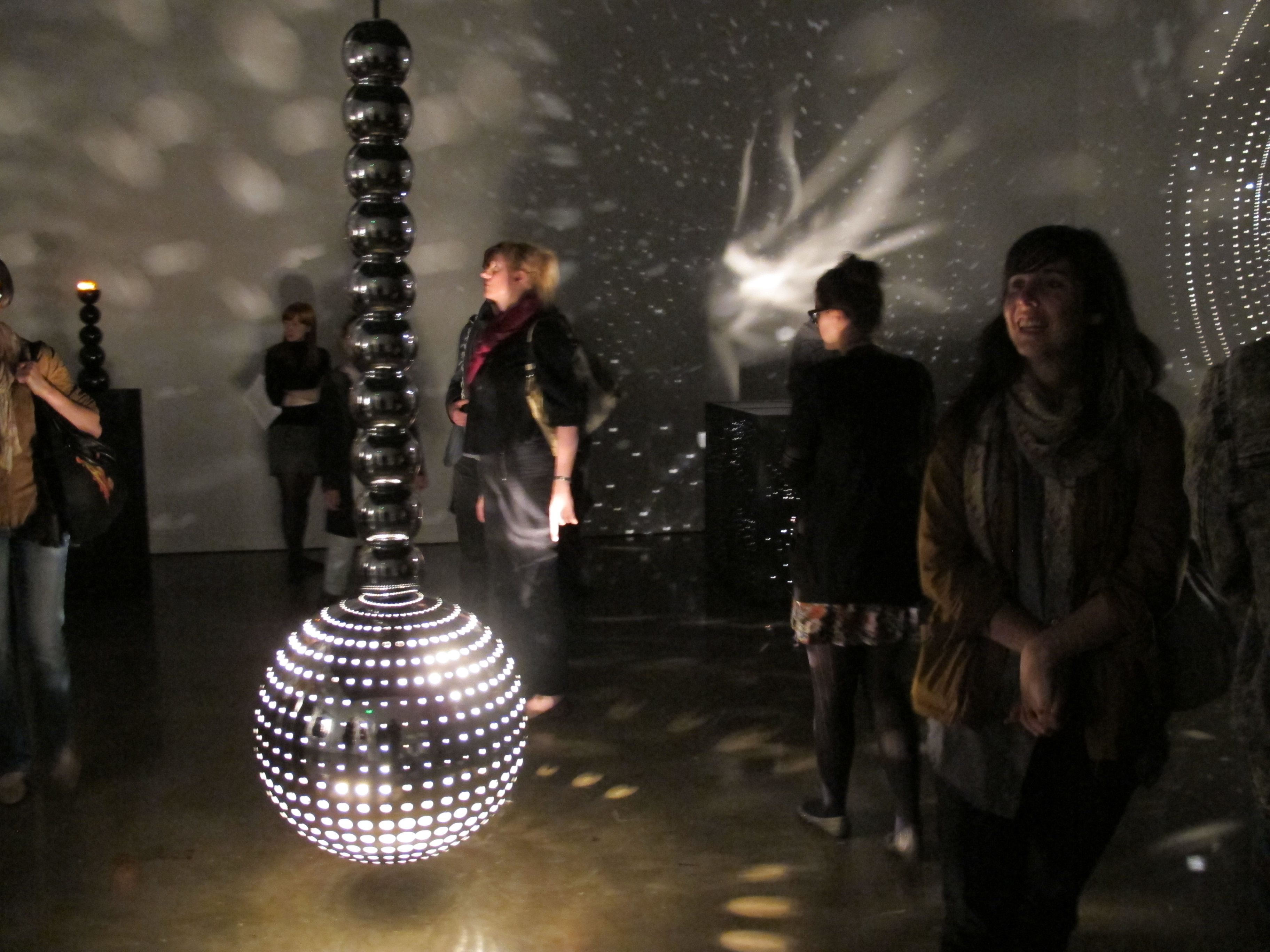 Viewers looking at the works in a gallery.