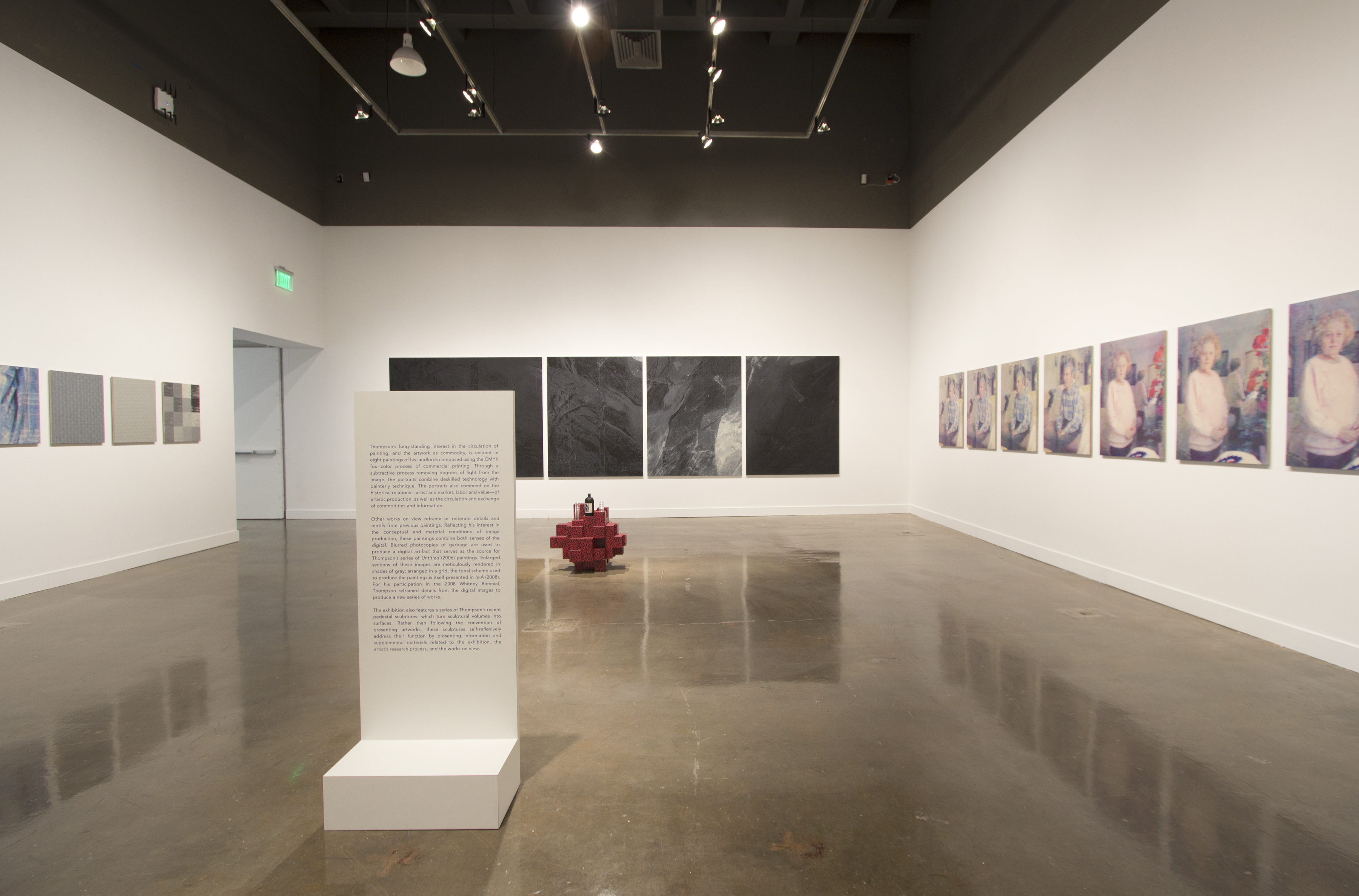 View of gallery with 3 walls showing many objects installed