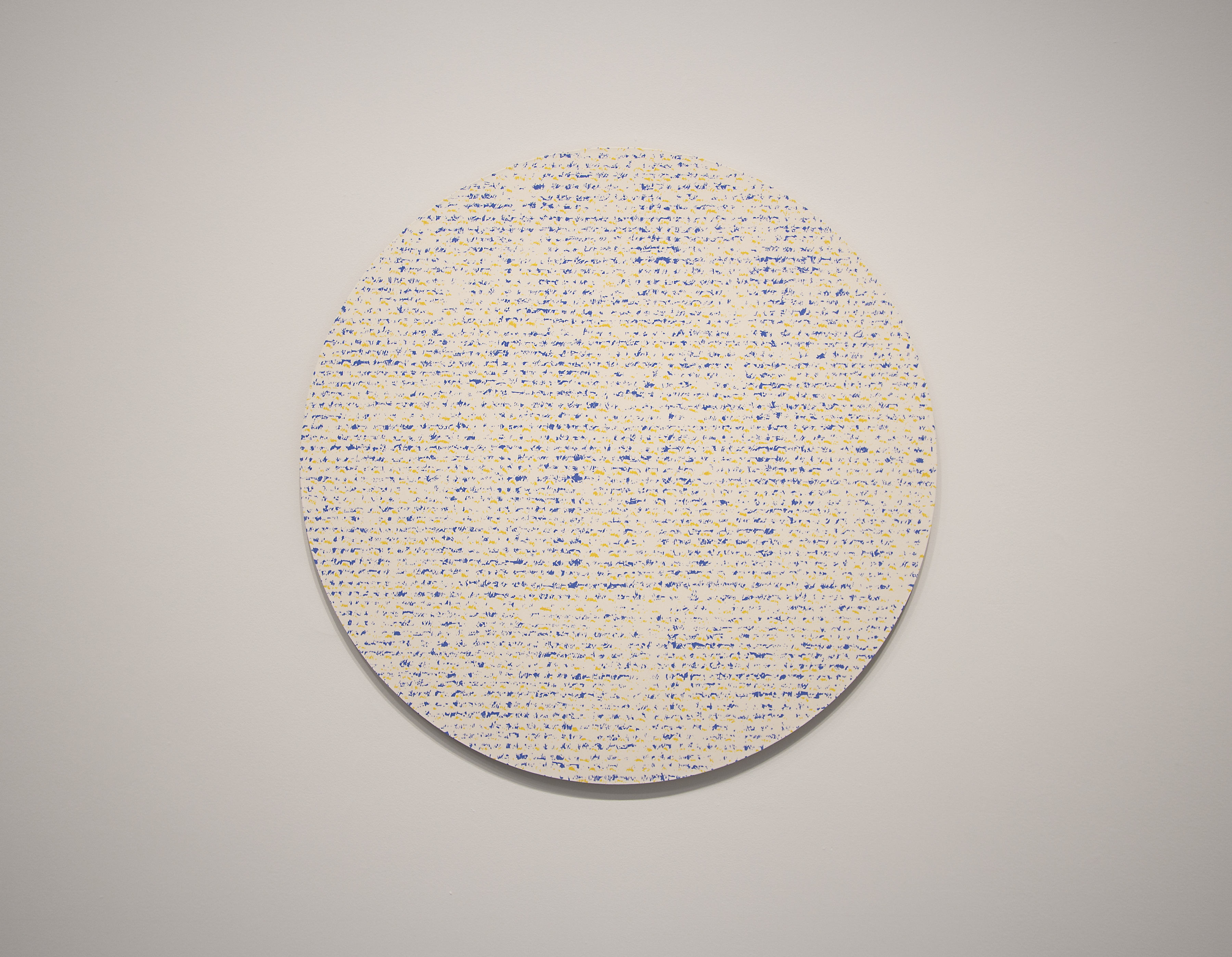 Round abstract painting of very small and tight polka dots.