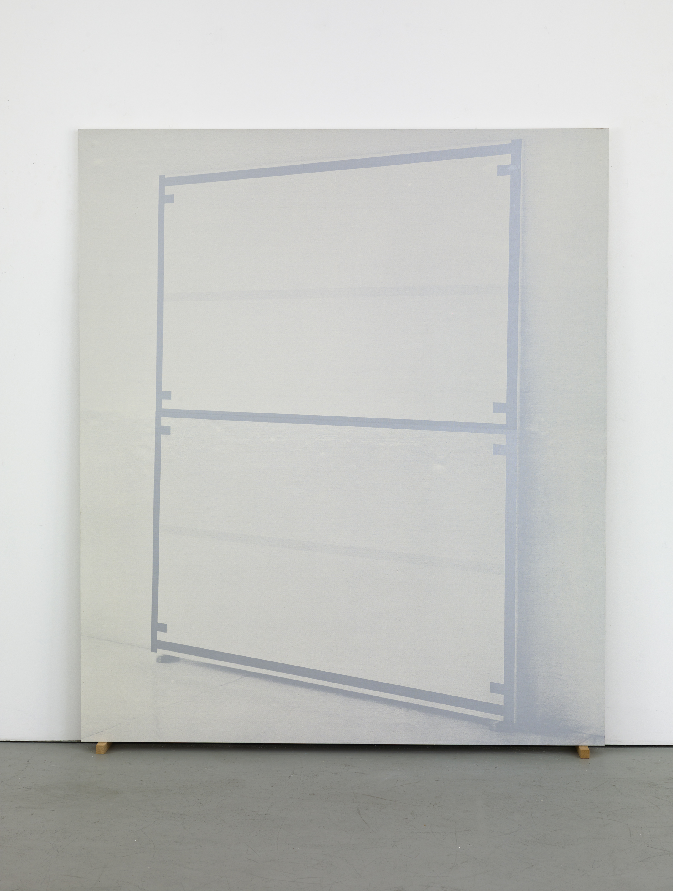 Large silkscreen of a leaning, angled canvas edged and bisected with a uniform brown line leans against the wall.