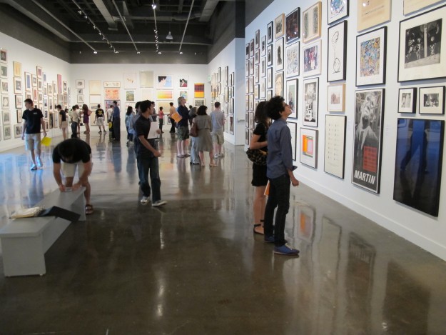 Students fill gallery looking at art.