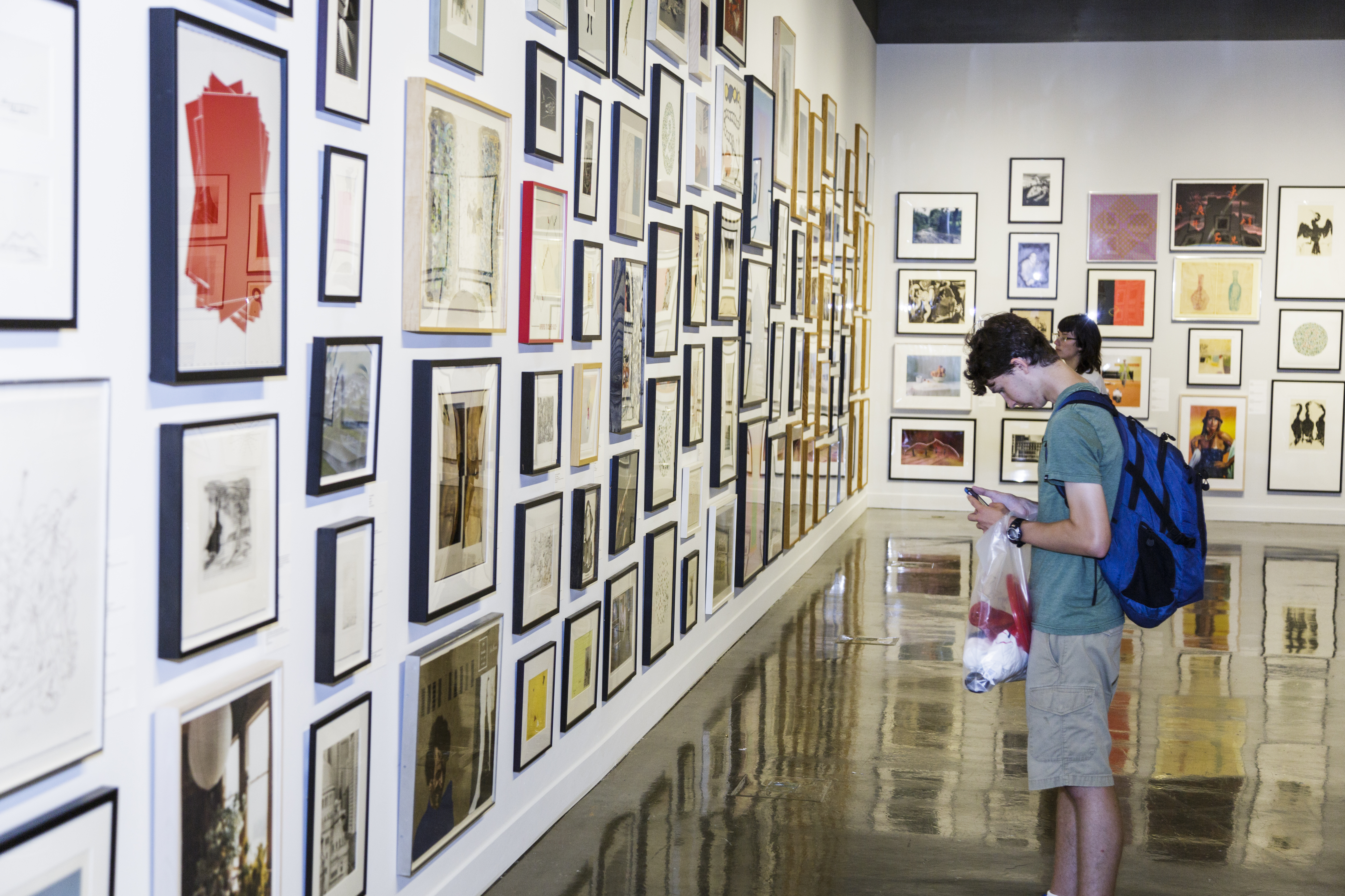 2 MIT Students looking at art in the museum.