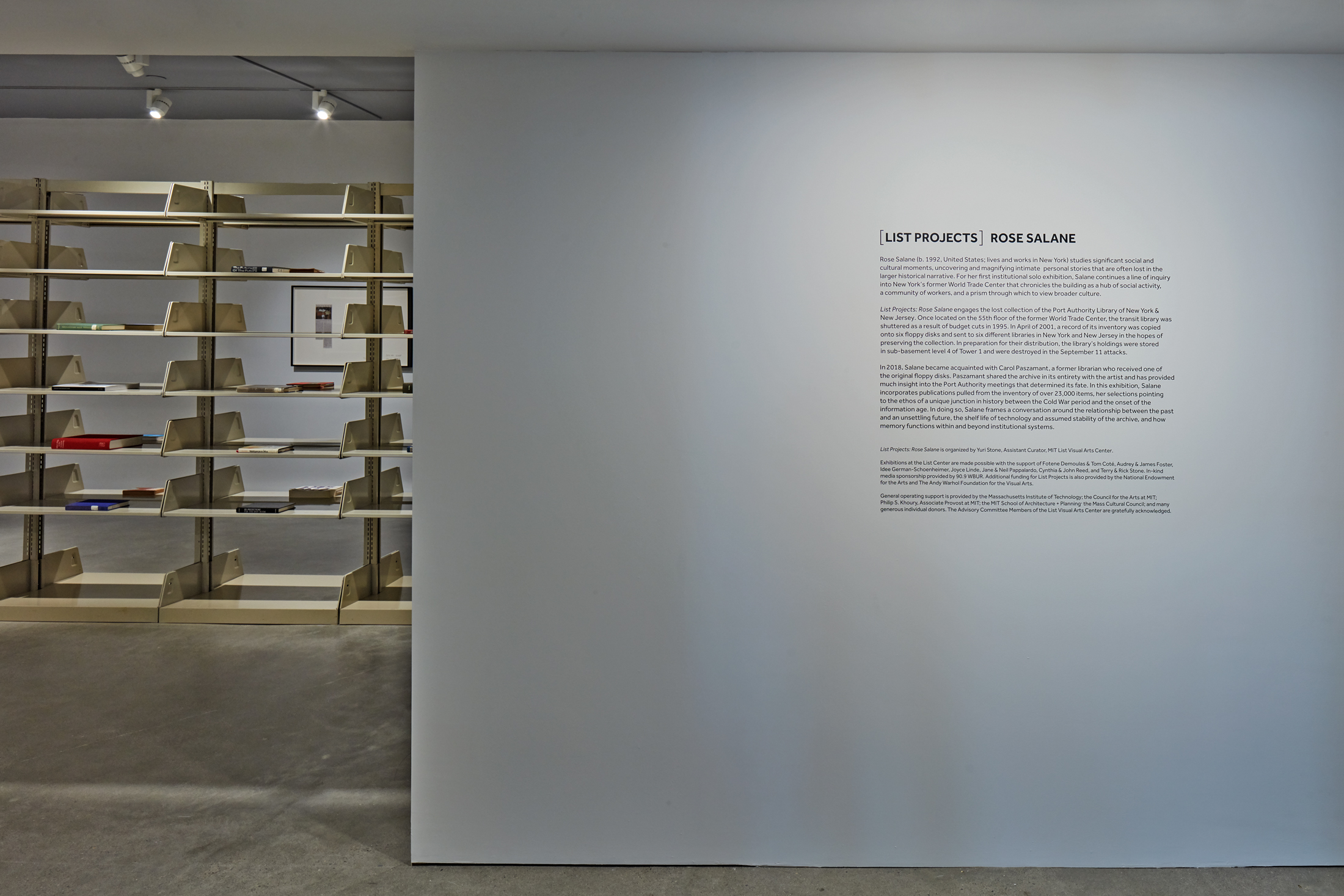 A gallery wall with vinyl letterrs reads "List Projects Rose Salane"