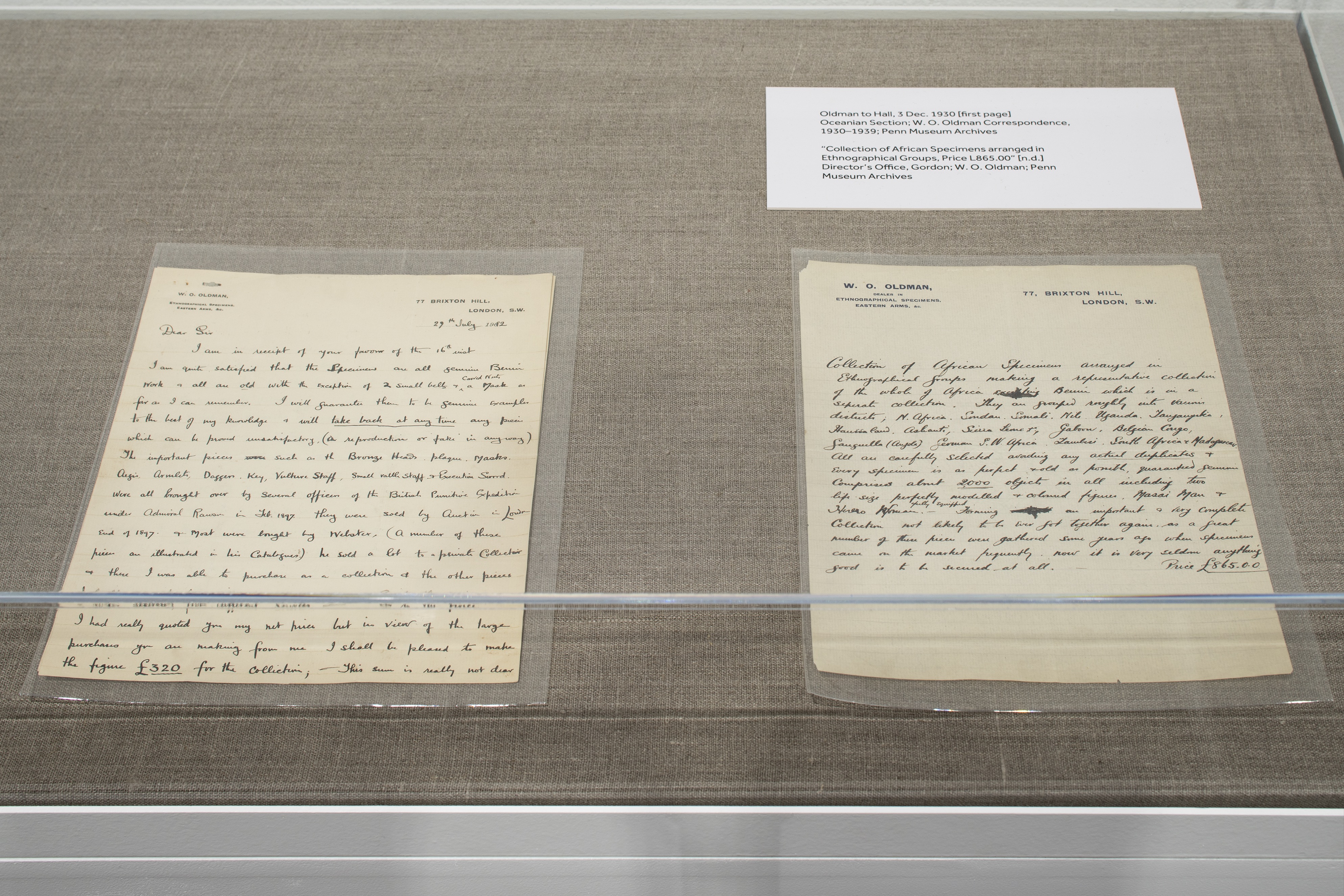 Letters from the year 1930 sit face up in a glass vitrine. The text is ornate cursive.