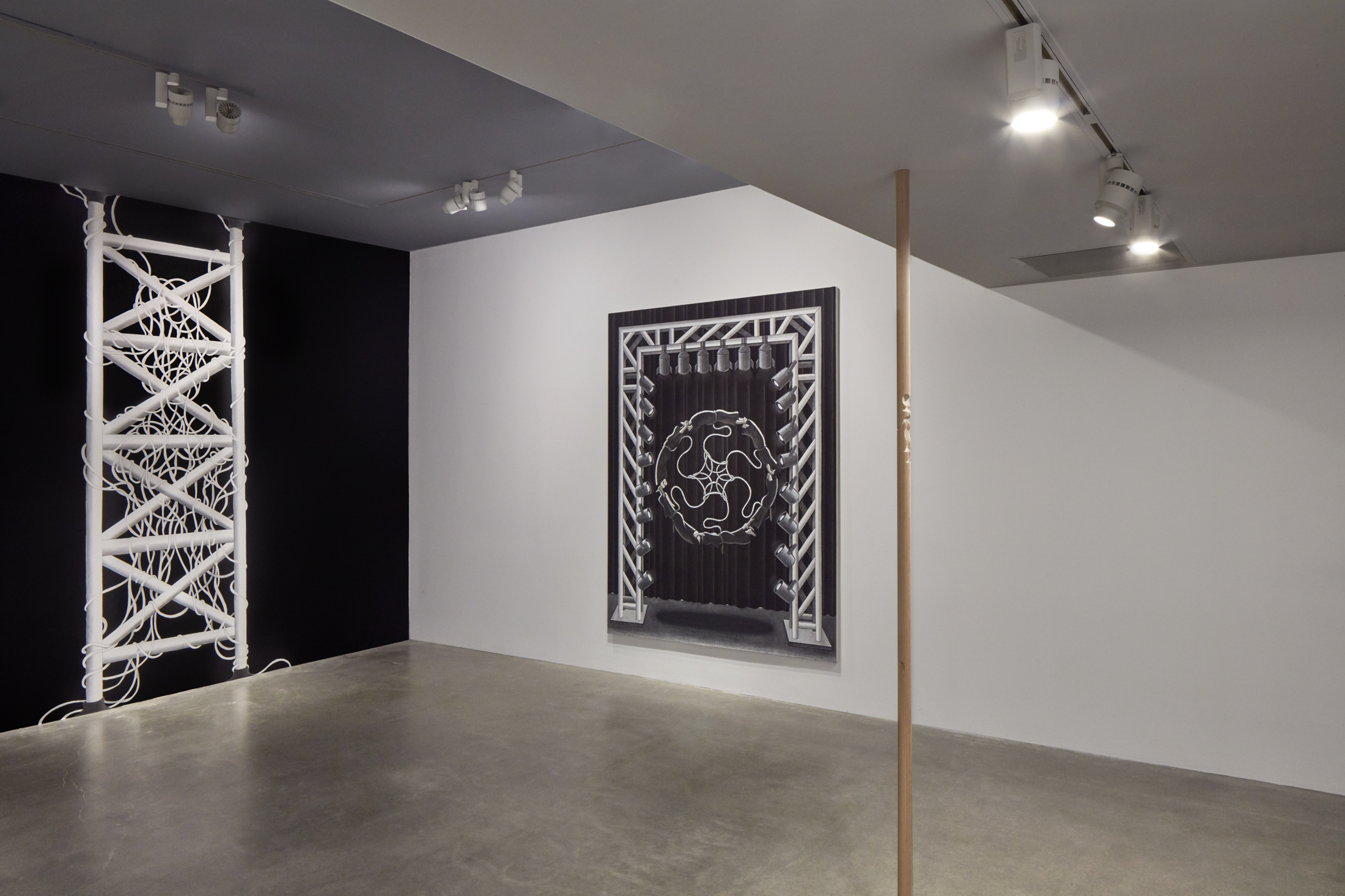 Installation view of project space gallery with pelvic bone painting hanging from the center, stagelight style painting in the background, and mural to the left.