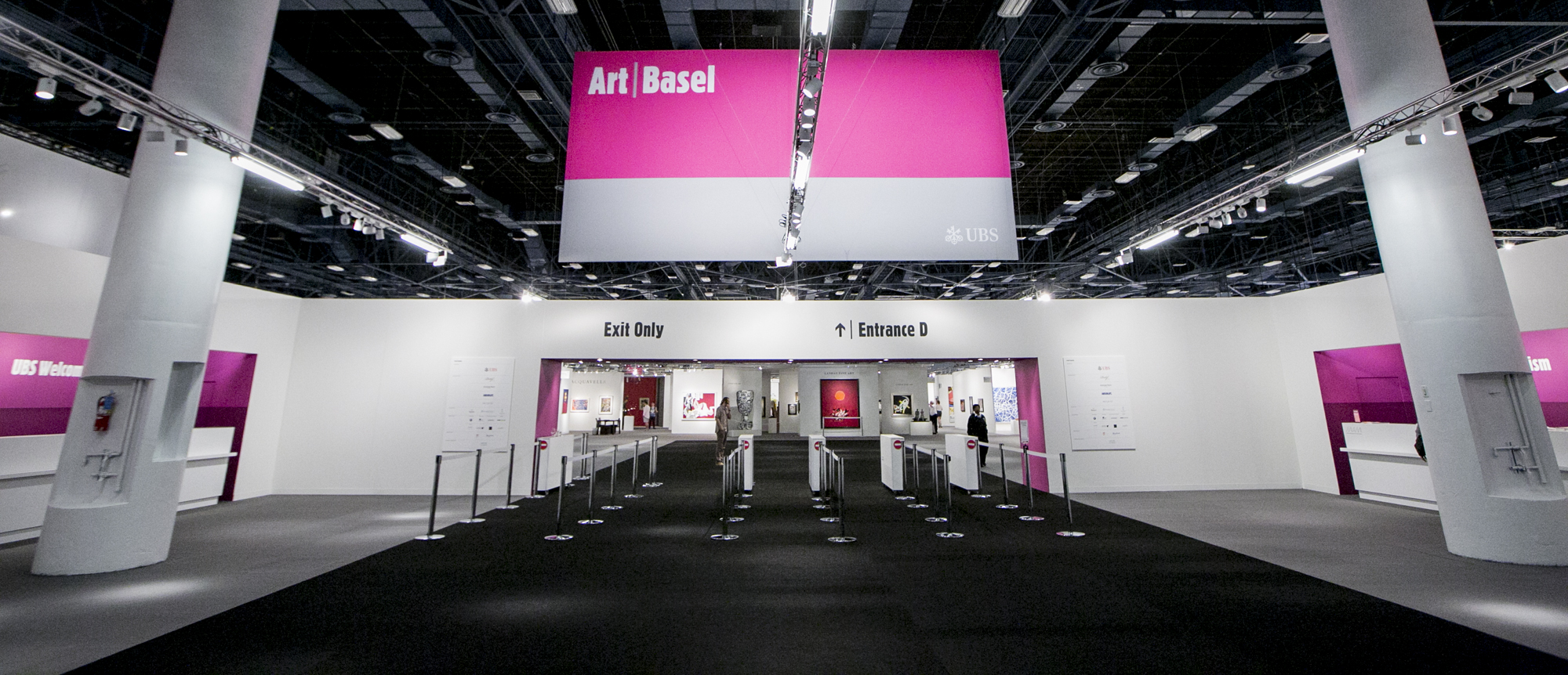 A pink banner reads &quot;Art Basel&quot; and under is an entrance and exit.