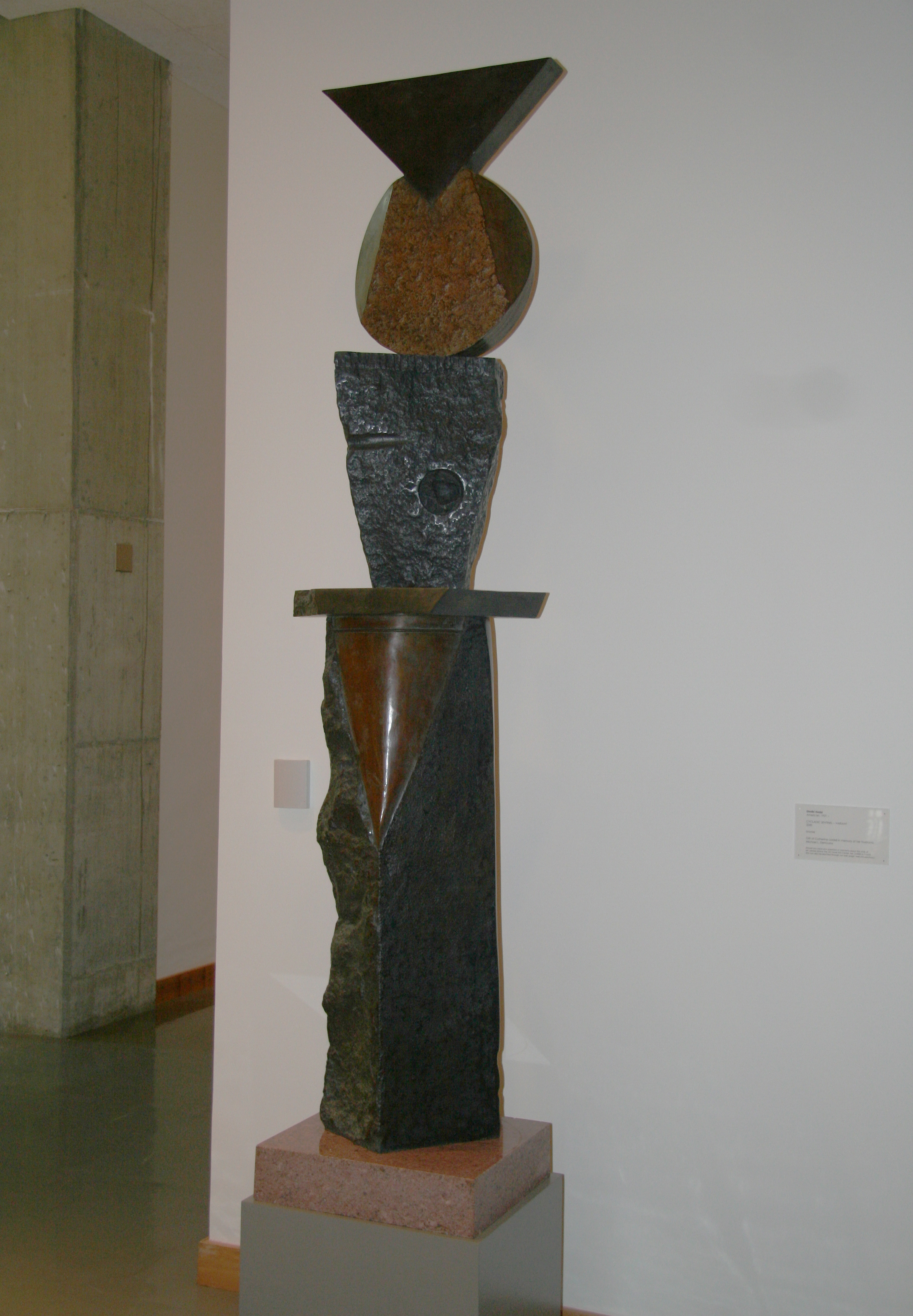Bronze sculpture featuring different shapes stacked on top of one another.