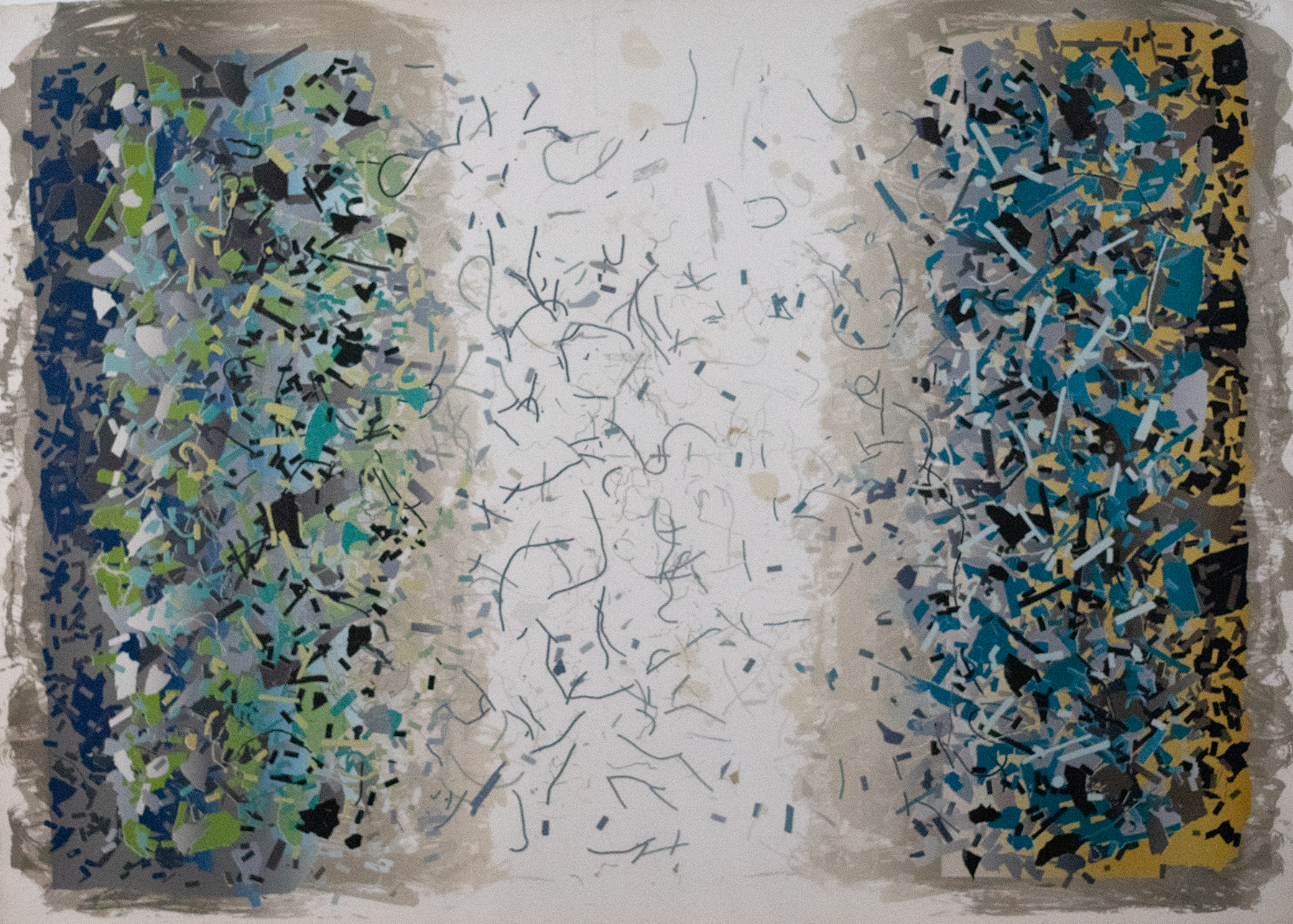 Lots of shapes on the left and right side resembling confetti as the shapes meet in the center.