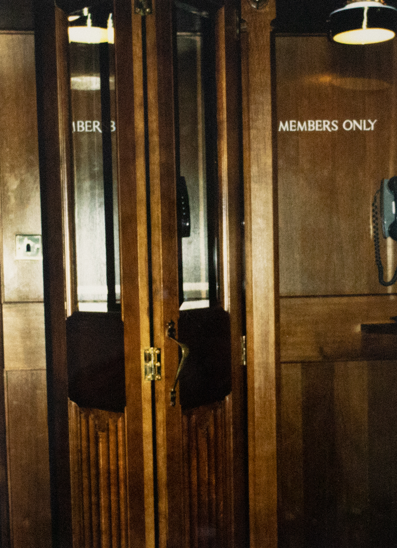 Photograph of a wooden door that reads &quot;Members Only&quot;