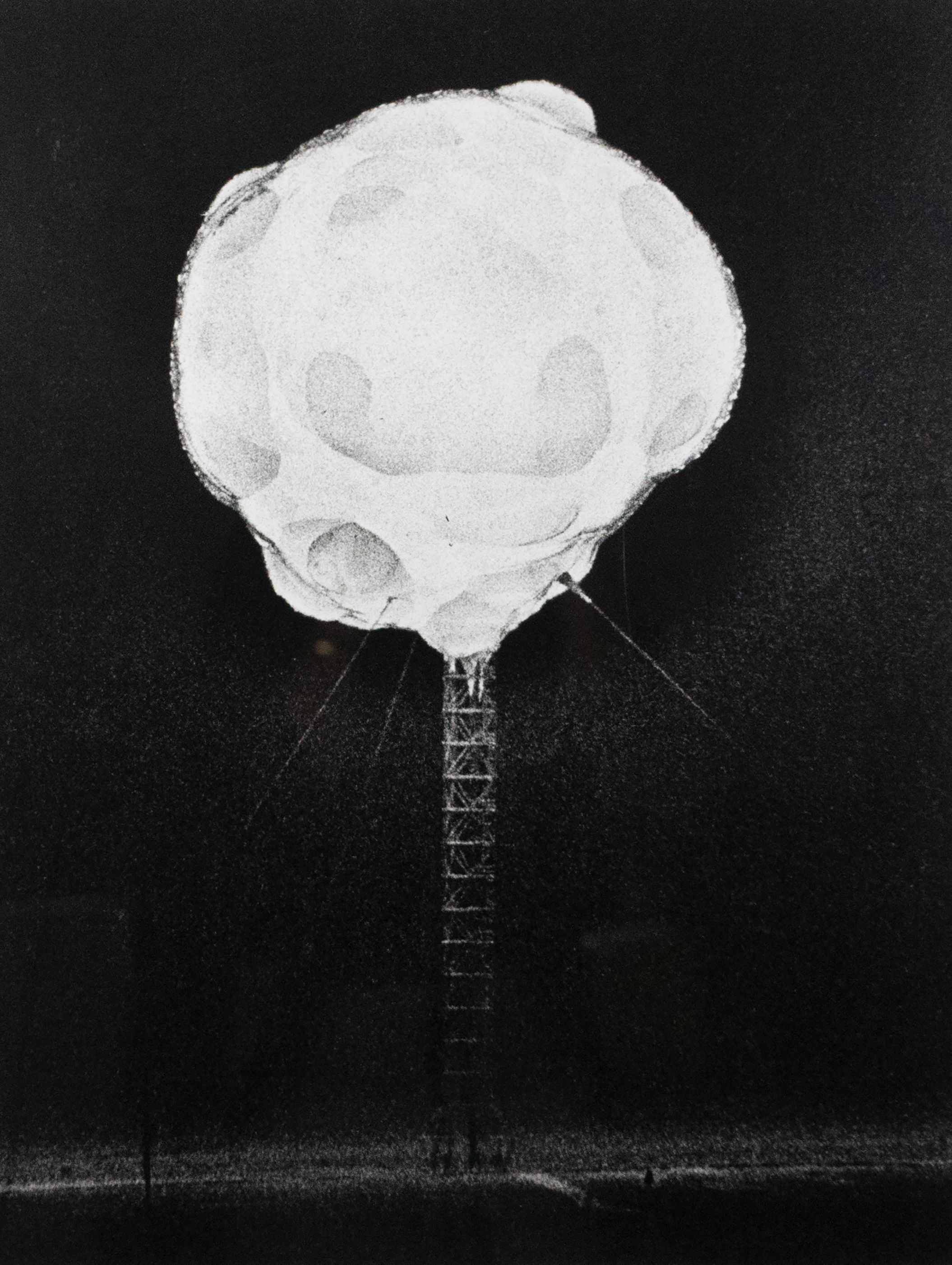 Tall metal scaffolding with a large white ball of smoke at the top.