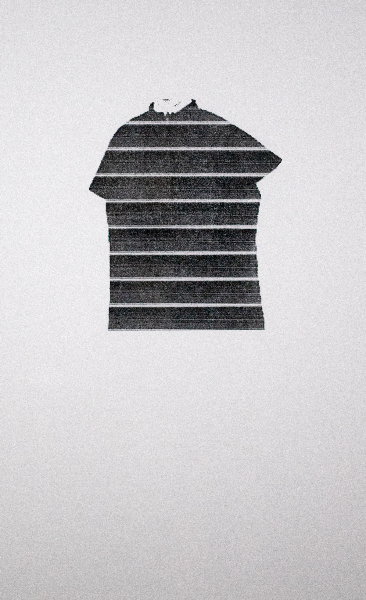 Black shape with white stripes resembling a shirt printed on white paper.