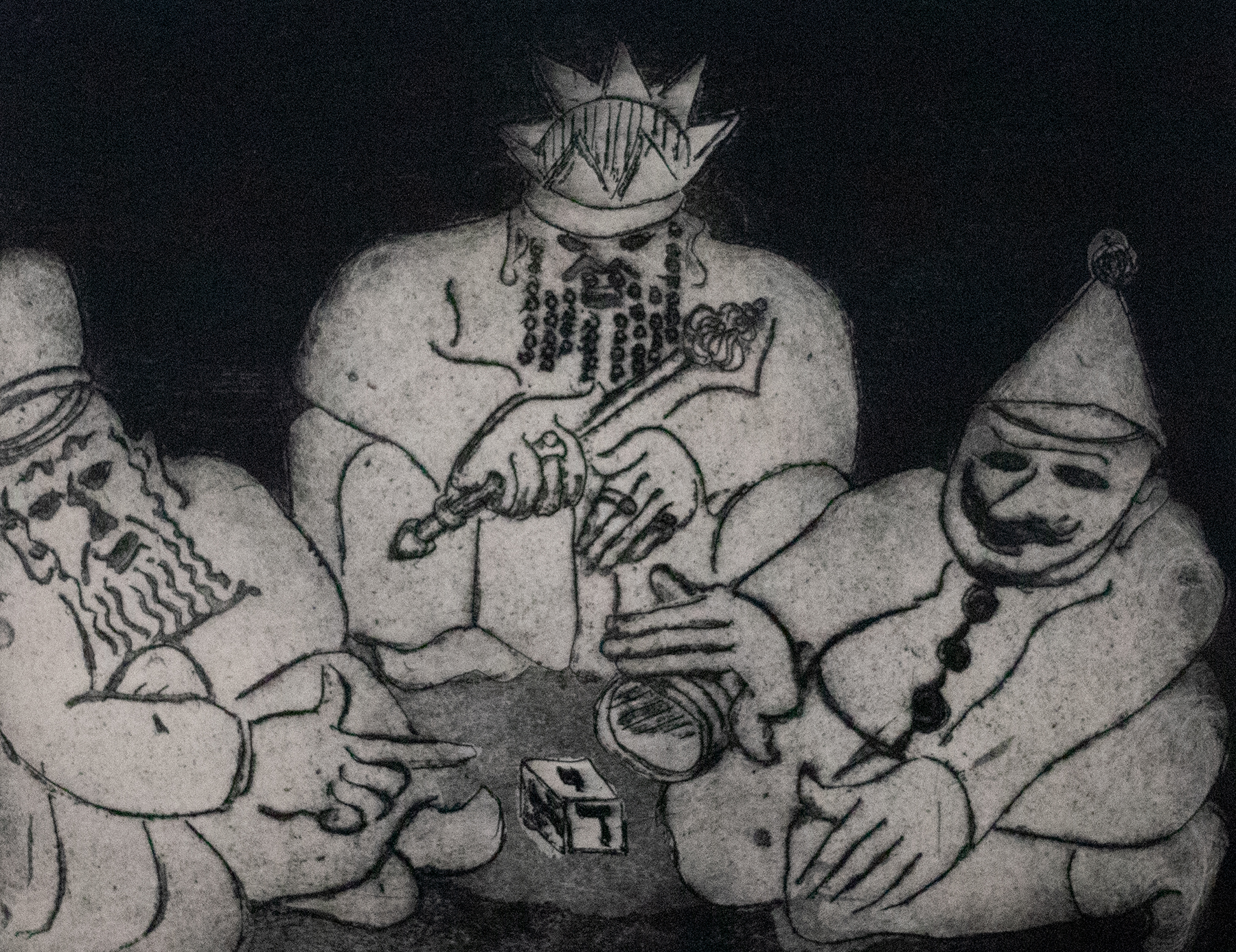 Three figures huddles around a table with a cube on the center.