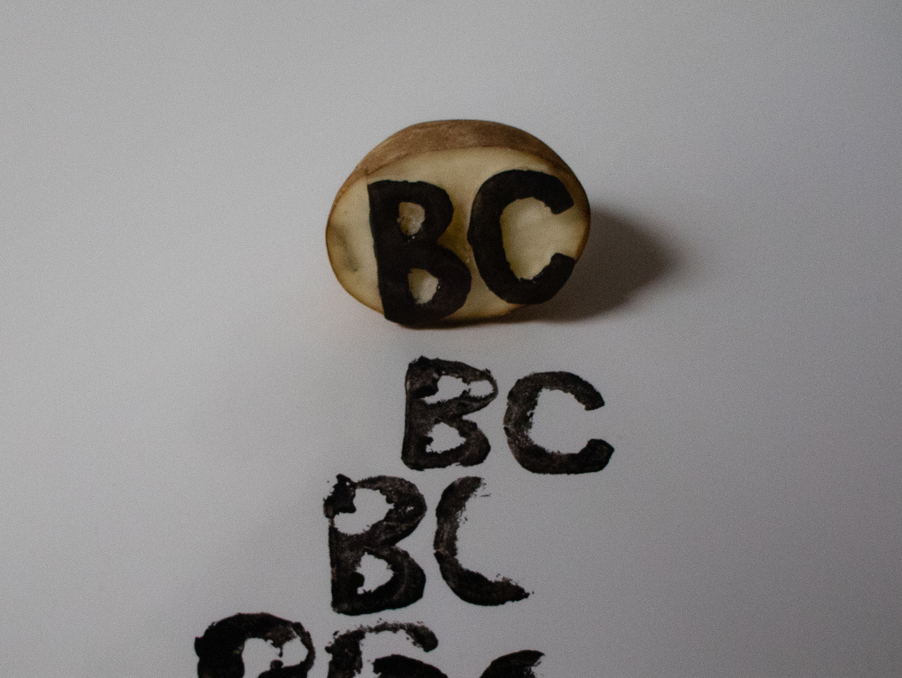 Print featuring the letters &quot;BC&quot; repeated four times.