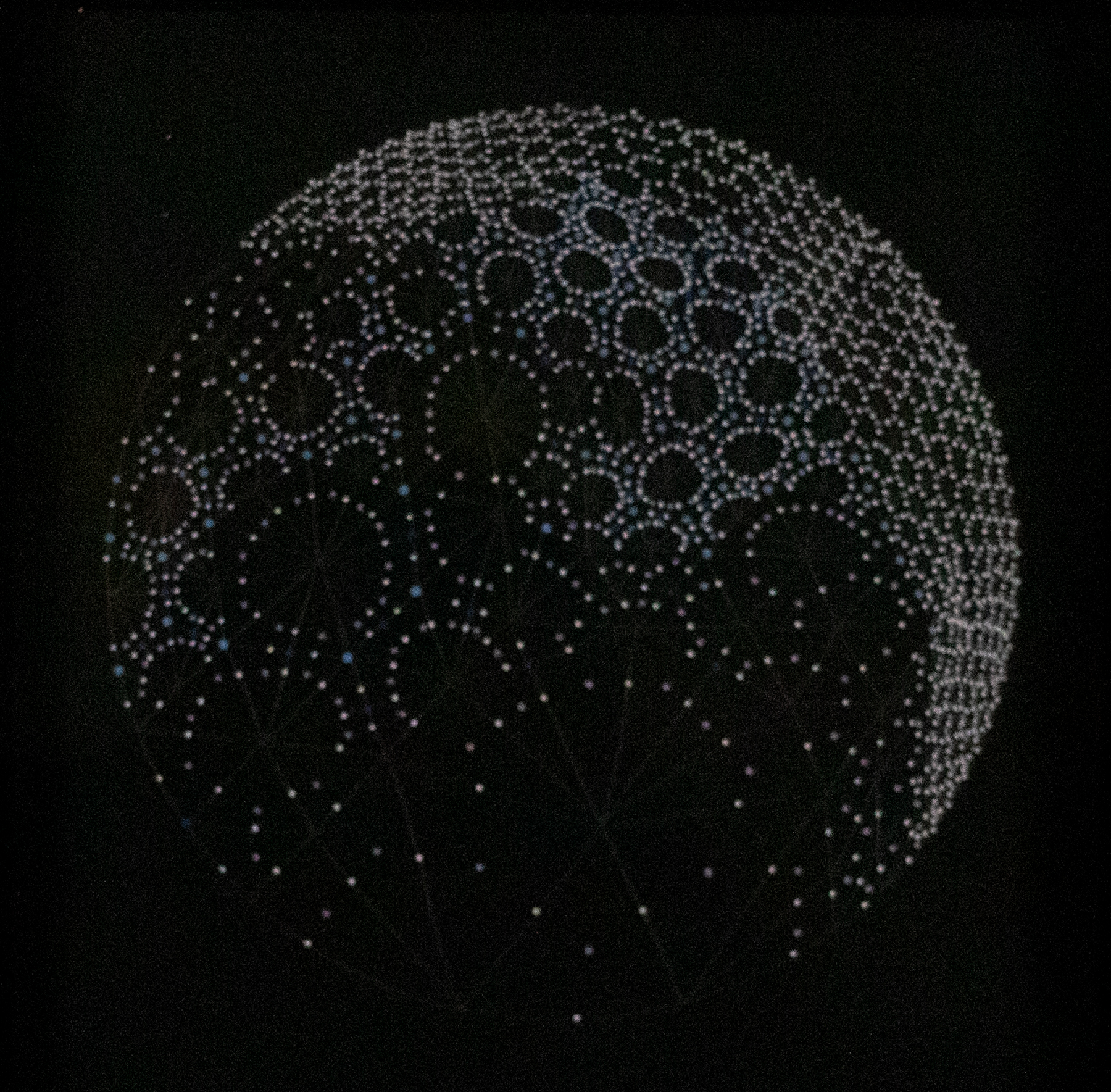Black background with a sphere shape in the center made up of lots of white dots and circles.