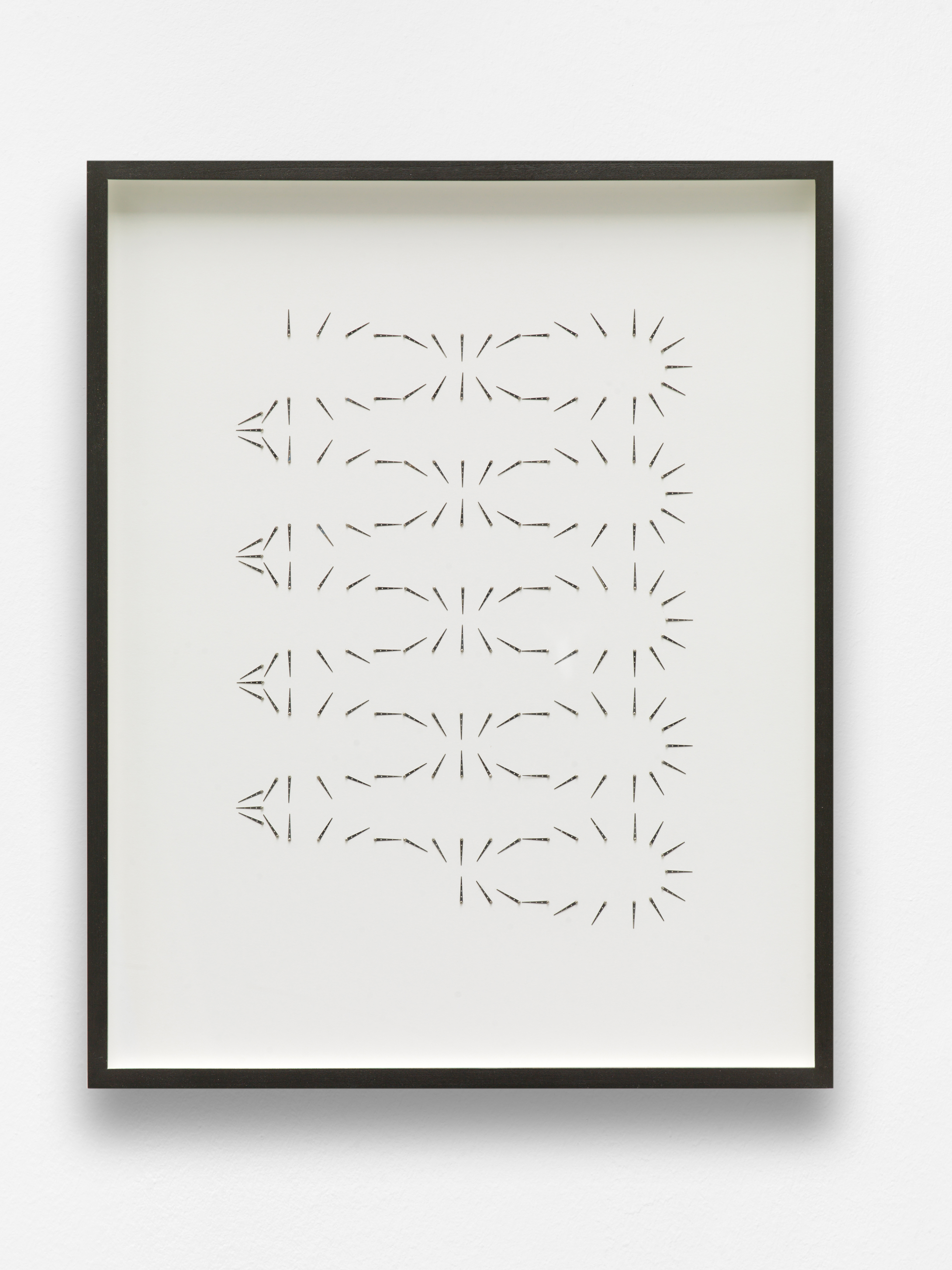Drawing consisting of black hatch marks which form different shapes like a sun and an oval repeated 5 times vertically.
