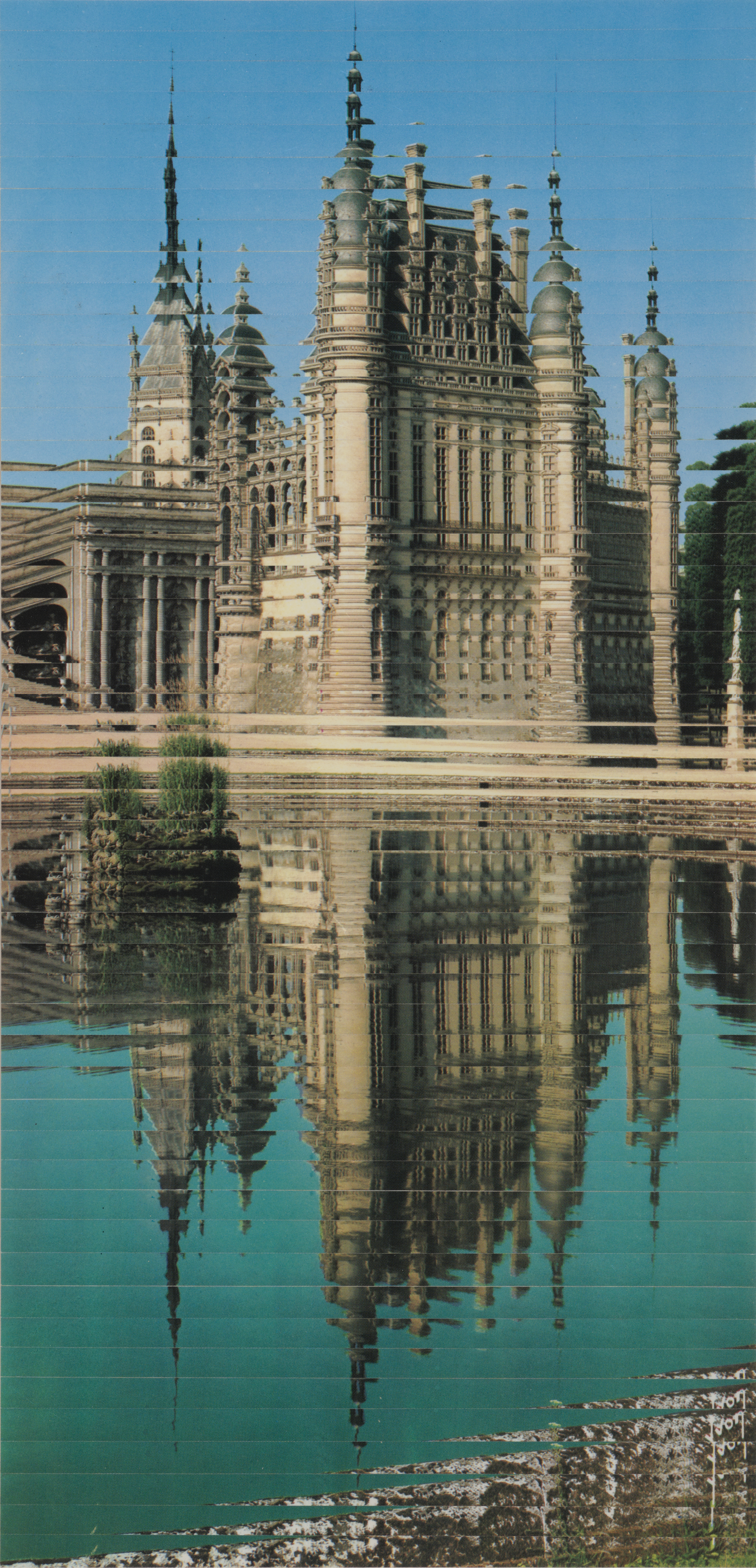 Image of a castle like building reflected in water.