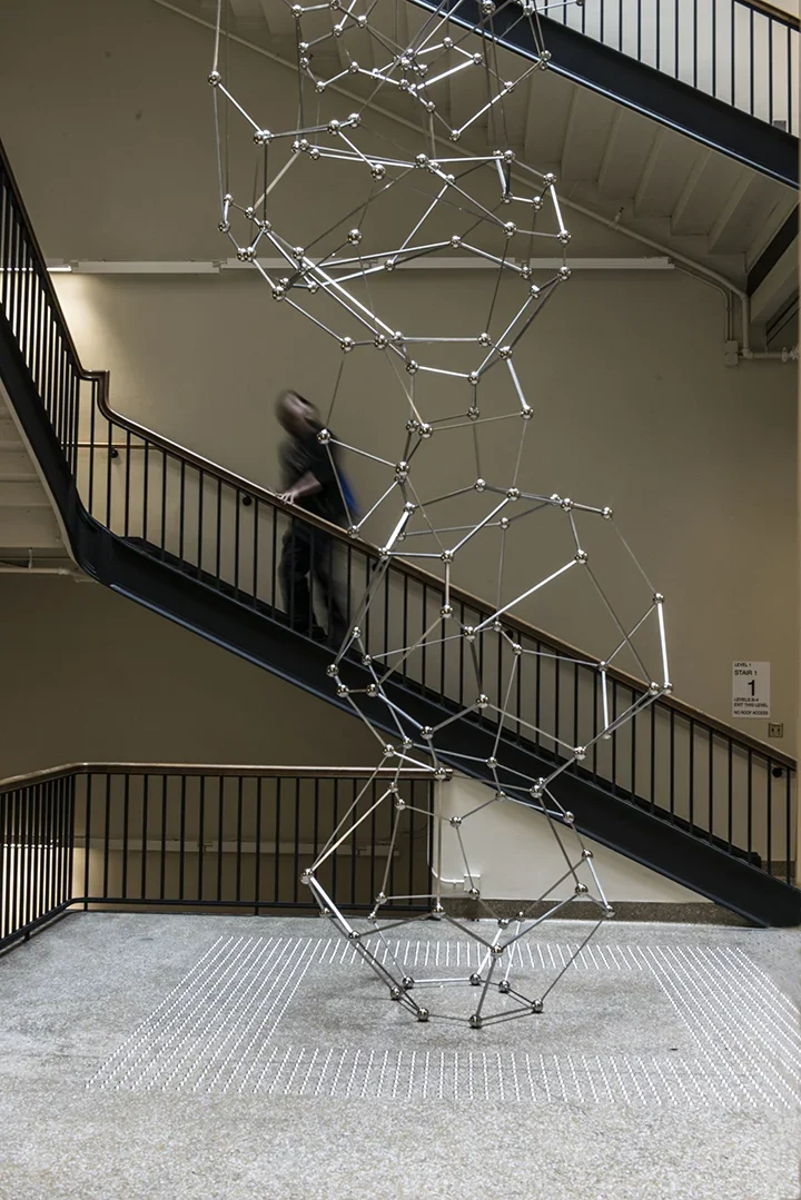 Sculpture made of thirty-three stainless steel polyhedrons reaching from the floor of the Simons Building to the skylight four stories above