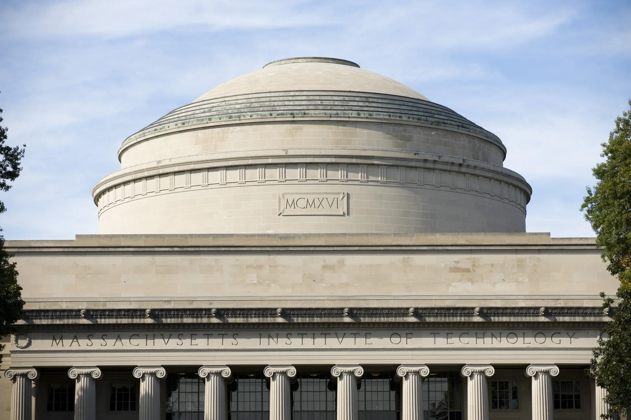 Photograph of a domed building with columns against a blue sky. 