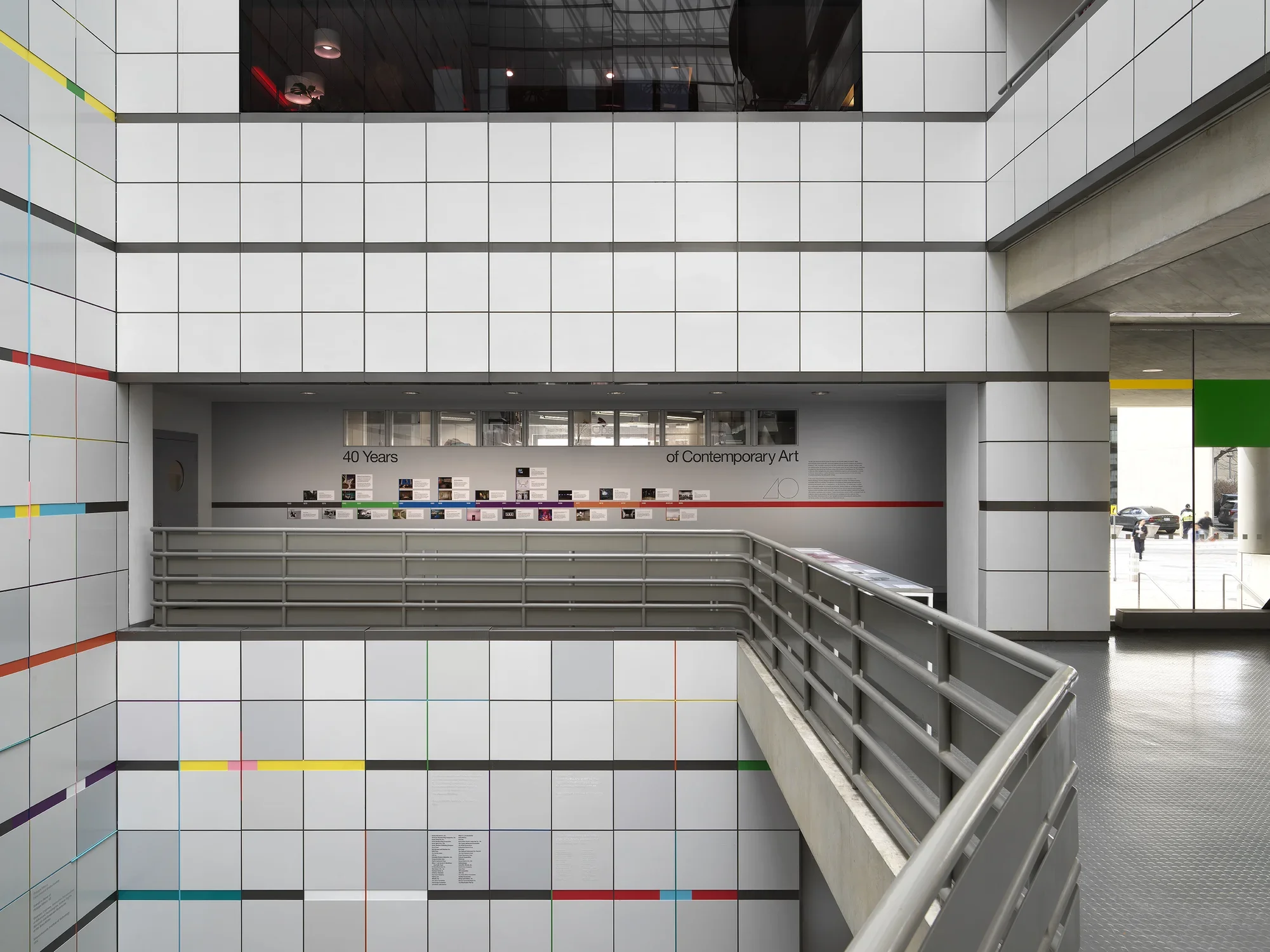 An open atrium with a colorful timeline and images is adhered on the background wall.