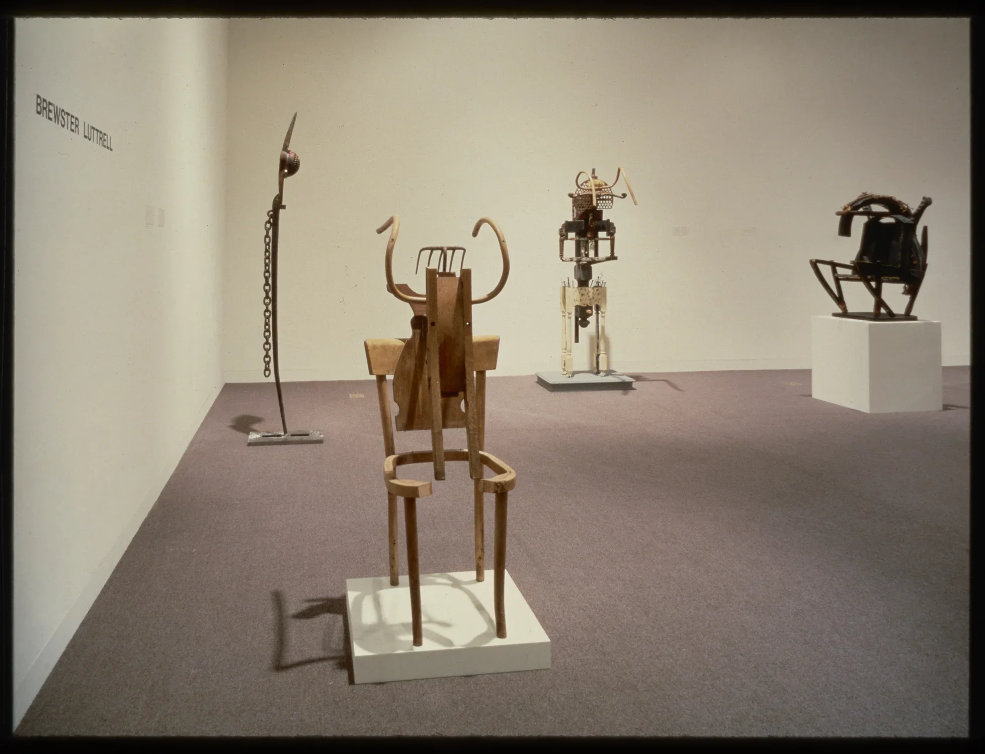 Abstract sculptures are scattered around the gallery. Each is propped up on pedestals and made from a range of materials.